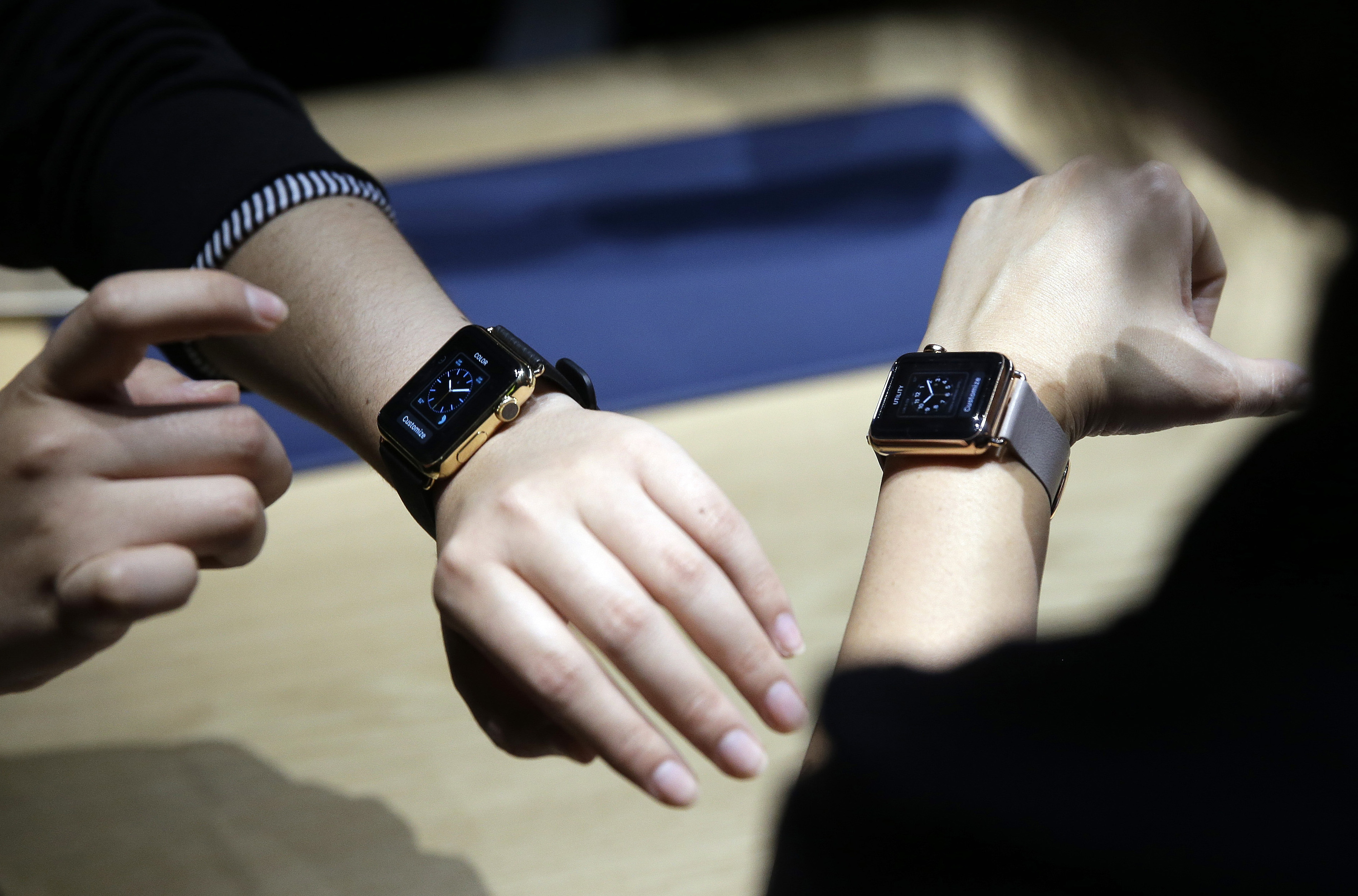 FILE - In this March 9, 2015 file photo, event attendees get a look at varieties of Apple Watch on display in the demo room after an Apple event in San Francisco. Apple Watch, available for pre-order on Friday, April 10, comes with a choice of watch case, band and size _ there are 54 possible configurations in all.  (AP Photo/Eric Risberg, File) (AP)