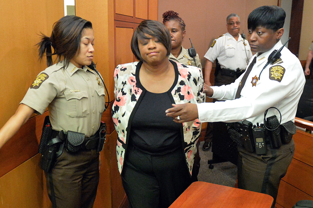 Former Atlanta Public Schools school research team director Tamara Cotman, center, is led to a holding cell after a jury found her guilty in the Atlanta Public Schools test-cheating trial, Wednesday, April 1, 2015, in Atlanta. (AP/Kent D. Johnson)