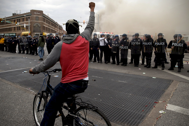 A protestor faces a line of police during clashes in Baltimore, Maryland April 27, 2015. (Reuters/Jim Bourg)