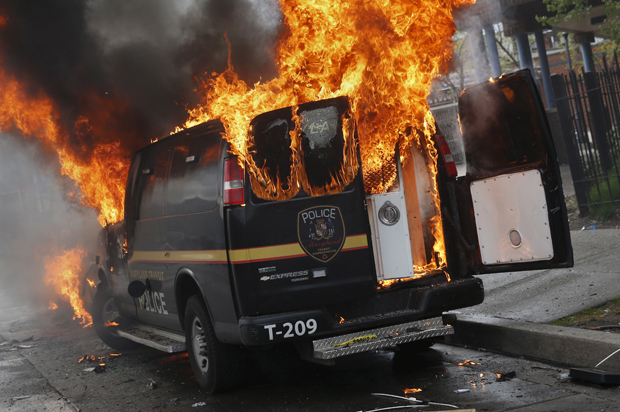 A Baltimore Metropolitan Police transport vehicle burns during clashes in Baltimore, Maryland April 27, 2015. (Reuters/Shannon Stapleton)