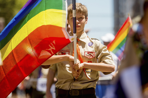Boy Scout Casey Chambers carries a rainbow flag during the San Francisco Gay Pride Festival in California June 29, 2014. (Reuters/Noah Berger)