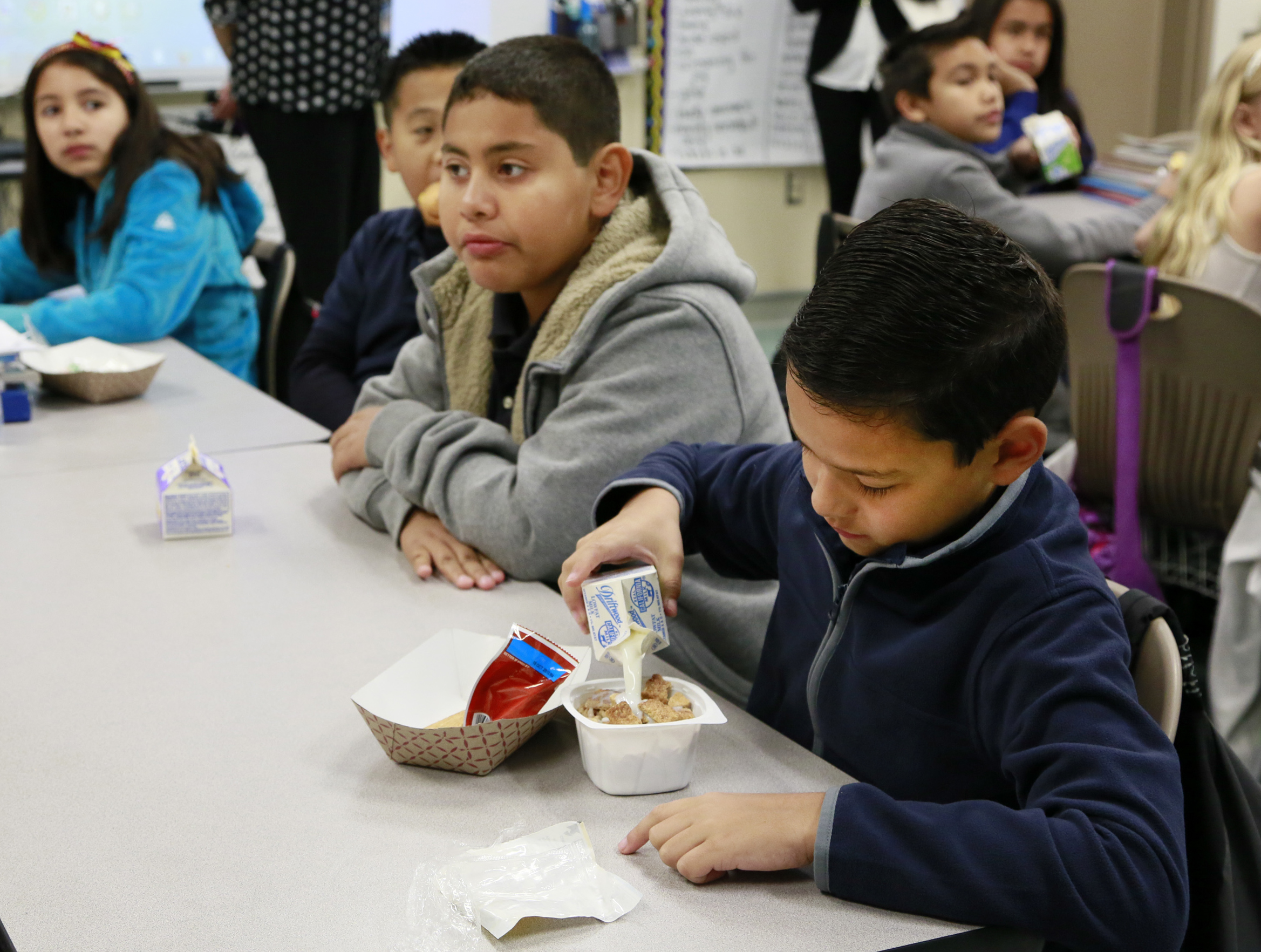In this Wednesday, April 8, 2015 photo, students are served breakfast at the Stanley Mosk Elementary School in Los Angeles. In this Los Angeles Unified School District program, and in other major urban school districts, breakfast is increasingly being served inside the classroom. The number of breakfasts served in the nations schools has doubled in the last two decades, a surge driven largely by a change in how districts deliver the food. Instead of providing low-income students free or reduced-price meals in the cafeteria, theyre increasingly serving all children in the classroom. (AP Photo/Nick Ut) (AP)