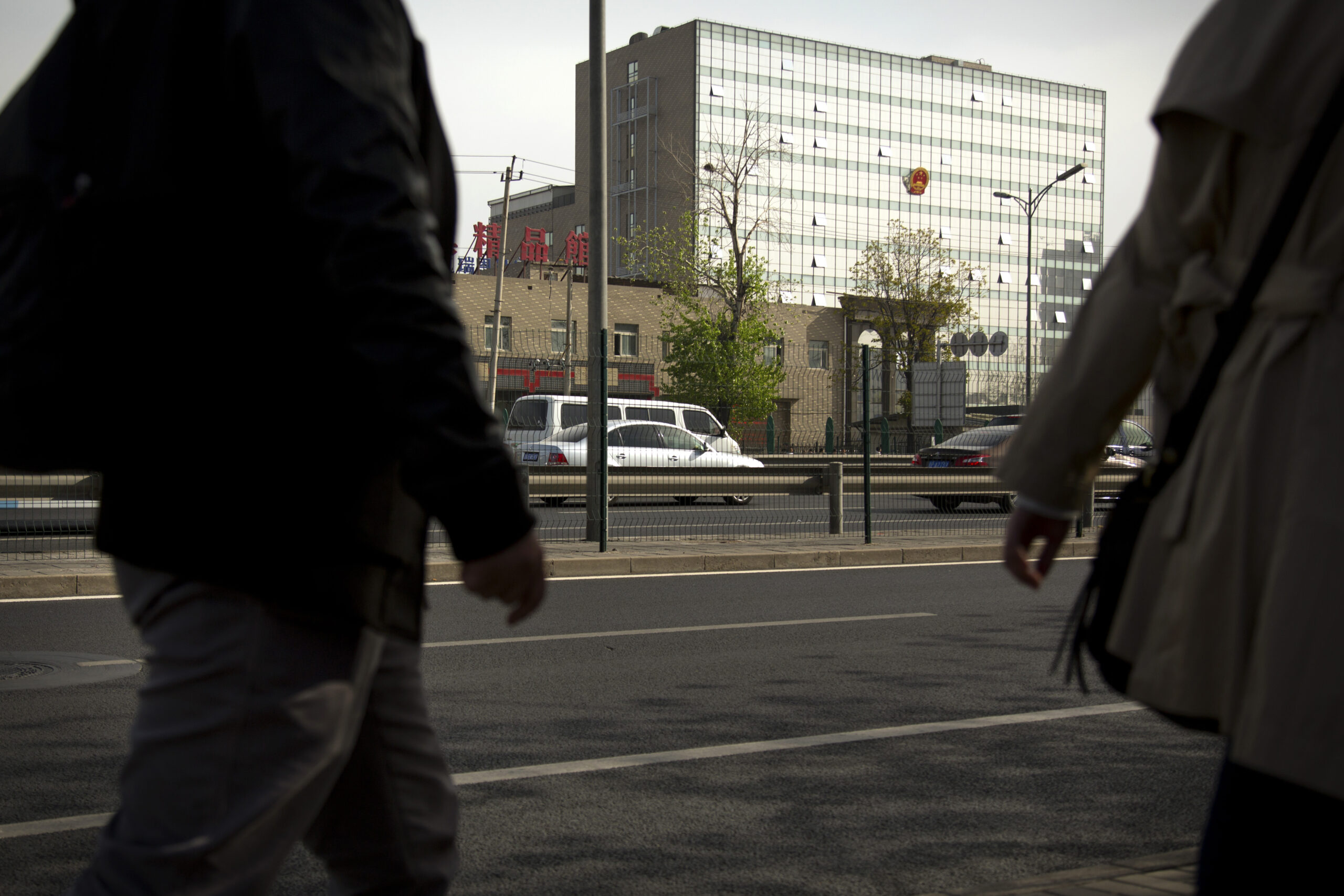 People walk near the Beijing No. 3 Intermediate Court in Beijing, Friday, April 17, 2015. Veteran Chinese journalist Gao Yu was sentenced to seven years in prison Friday for leaking a document detailing the Communist Party leadership's resolve to aggressively target civil society and press freedom as a threat to its monopoly on power. (AP Photo/Mark Schiefelbein) (Mark Schiefelbein)