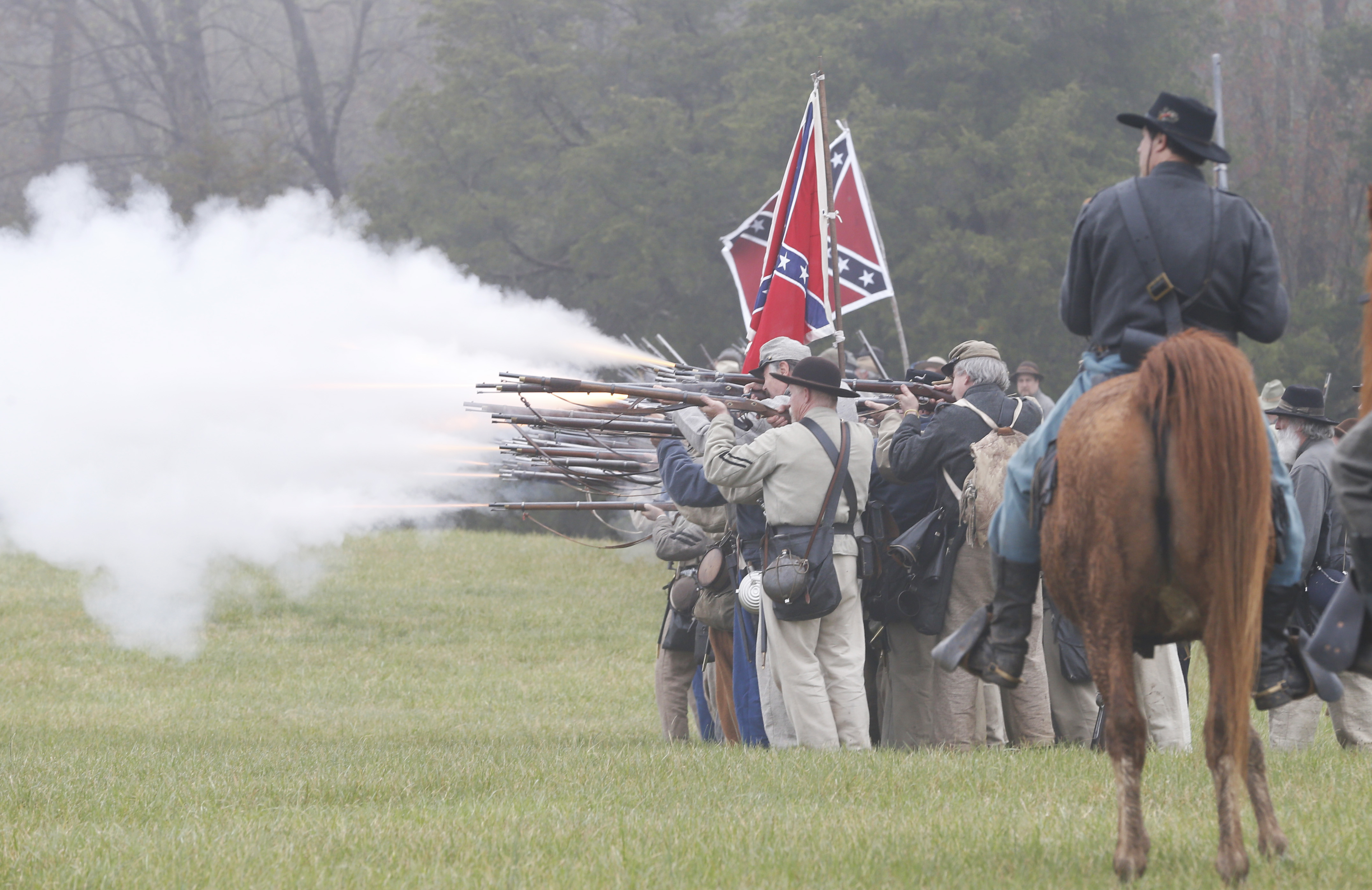 Confederate troops fire muskets at Union troops during a re-enactment of the Battle of Appomattox Courthouse as part of the commemoration of the 150th anniversary of the surrender of the Army of Northern Virginia at Appomattox Court House in Appomattox, Va., Thursday, April 9, 2015.  The battle was the final battle of the army of Confederate General Robert E. Lee before his surrender to Union troops.  (AP Photo/Steve Helber) (AP)
