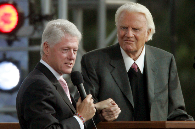 Former president Bill Clinton, left, speaks alongside the Rev. Billy Graham on the second night of the Greater New York Billy Graham Crusade Saturday, June 25, 2005 at Flushing Meadows Corona Park in New York borough of Queens. (AP Photo/Frank Franklin II) (Frank Franklin Ii)