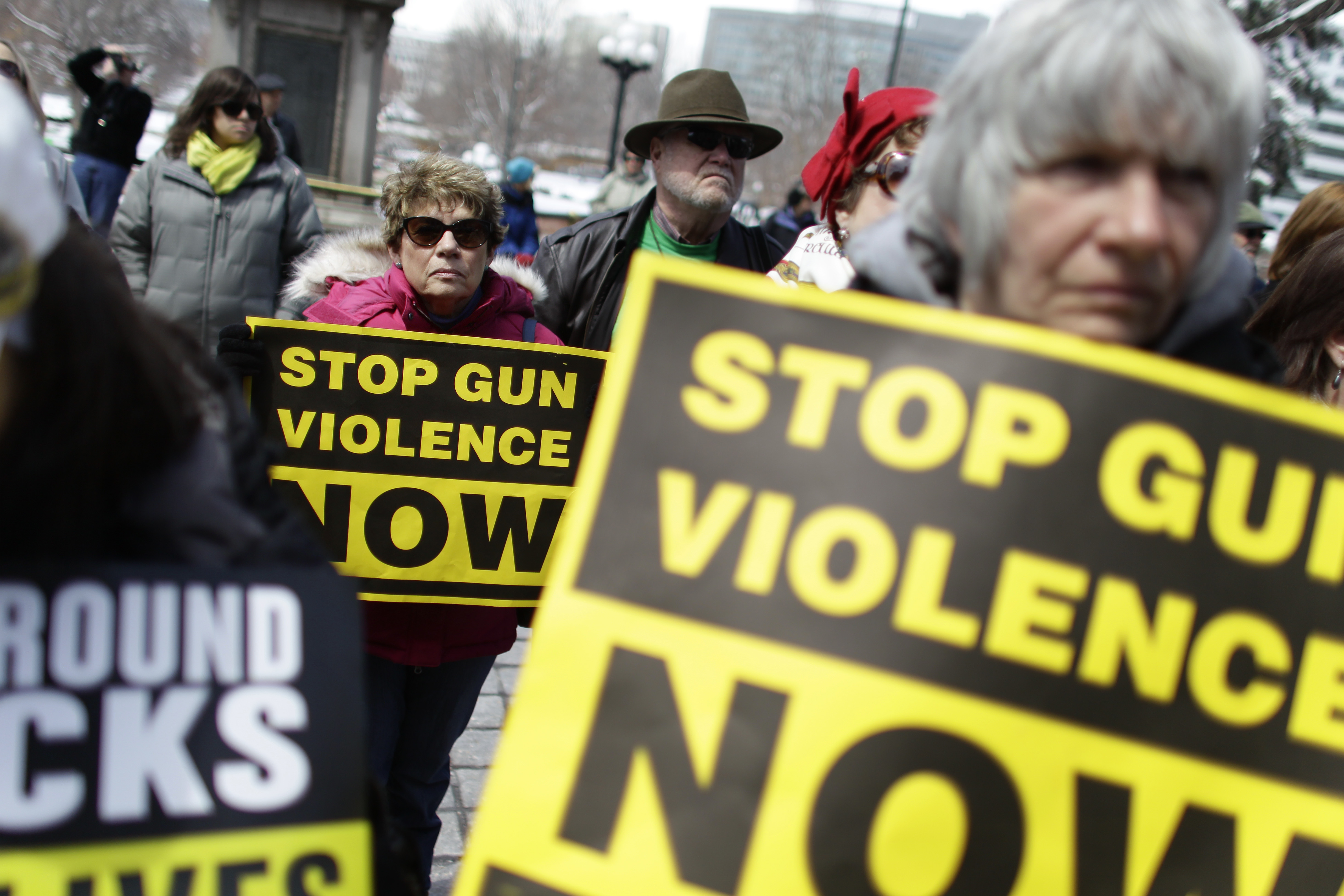 FILE - In this April 18, 2013 file photo, community gun safety advocates and members of the public hold signs during a rally and vigil to honor victims of gun violence, sponsored by Colorado Ceasefire, on the steps of the Colorado State Capitol, in Denver. When a gunman opened fire inside a packed movie theater in July of 2012, killing 12, it helped revive the national debate over gun control. But, as the trial of theater shooter James Holmes is scheduled to begin Monday, April 27, 2015, Colorados gun debate has quieted down. Its in a sort of gridlock, said nonpartisan Denver pollster Floyd Ciruli. (AP Photo/Brennan Linsley, file) (AP)