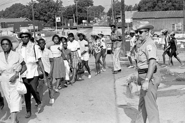 Neshoba County Deputy Sheriff Cecil Price watches marchers as they pass through Philadelphia, Miss., during a memorial for three slain civil rights workers, June 21, 1965. (AP/Jack Thornell)