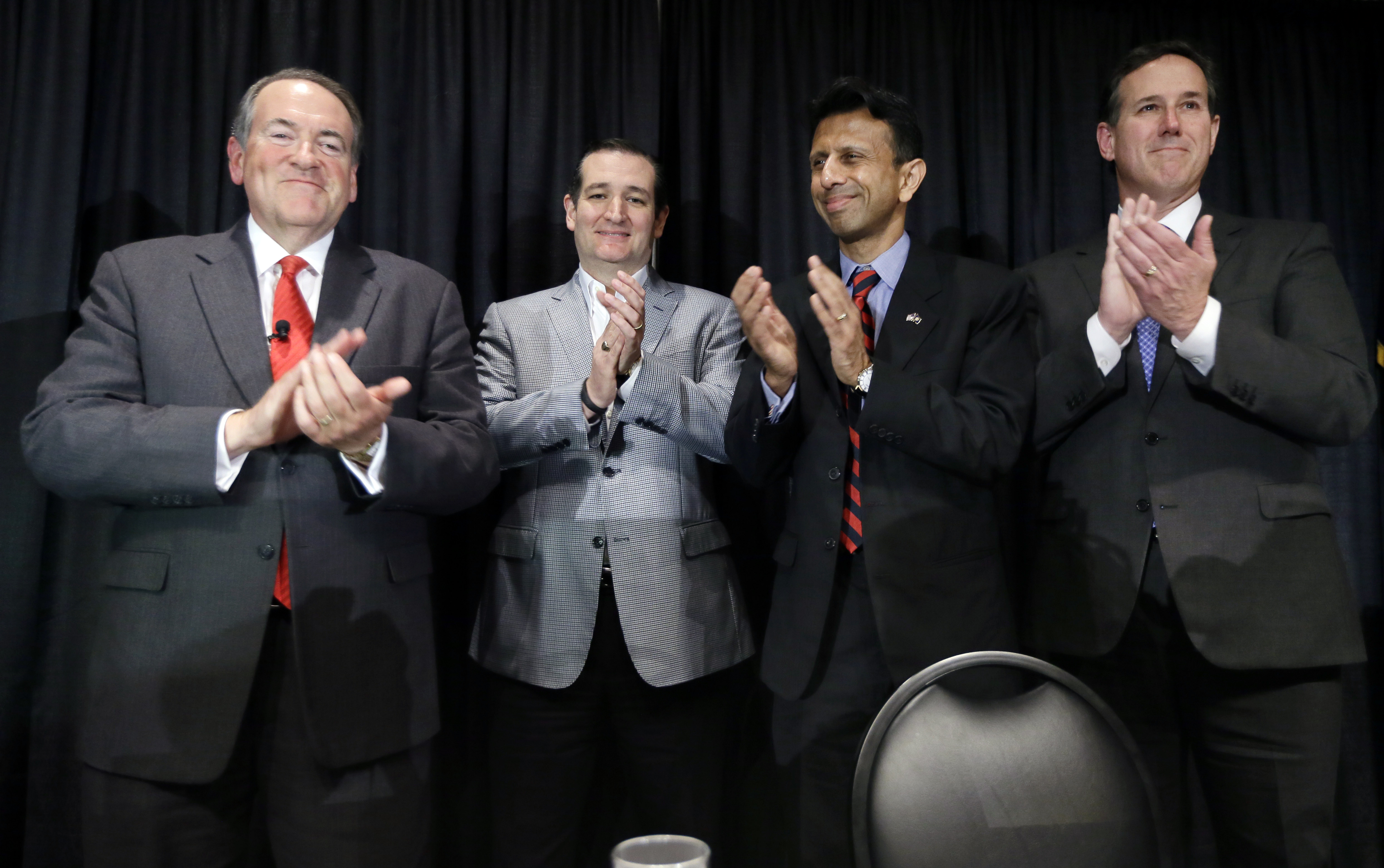 Former Arkansas Gov. Mike Huckabee, from left, U.S. Sen. Ted Cruz, R-Texas, Louisiana Gov. Bobby Jindal and former Pennsylvania Sen. Rick Santorum gather on stage after speak at the Homeschool Iowa's Capitol Day, Thursday, April 9, 2015, in Des Moines, Iowa. (AP Photo/Charlie Neibergall) (AP)