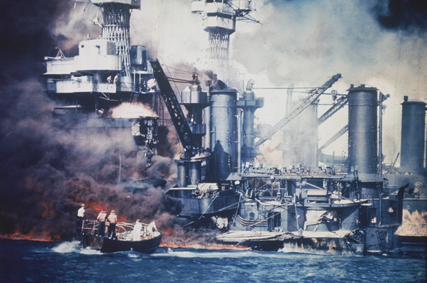 A small boat rescues a USS West Virginia crew member from the water after the Japanese bombing of Pearl Harbor, Hawaii on Dec. 7, 1941. (AP)