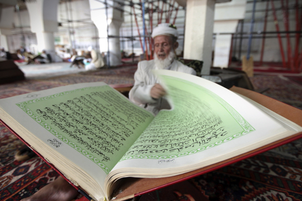 A man reads the Koran in a mosque in Sanaa, June 27, 2014. (Reuters/Mohamed Al-sayaghi)