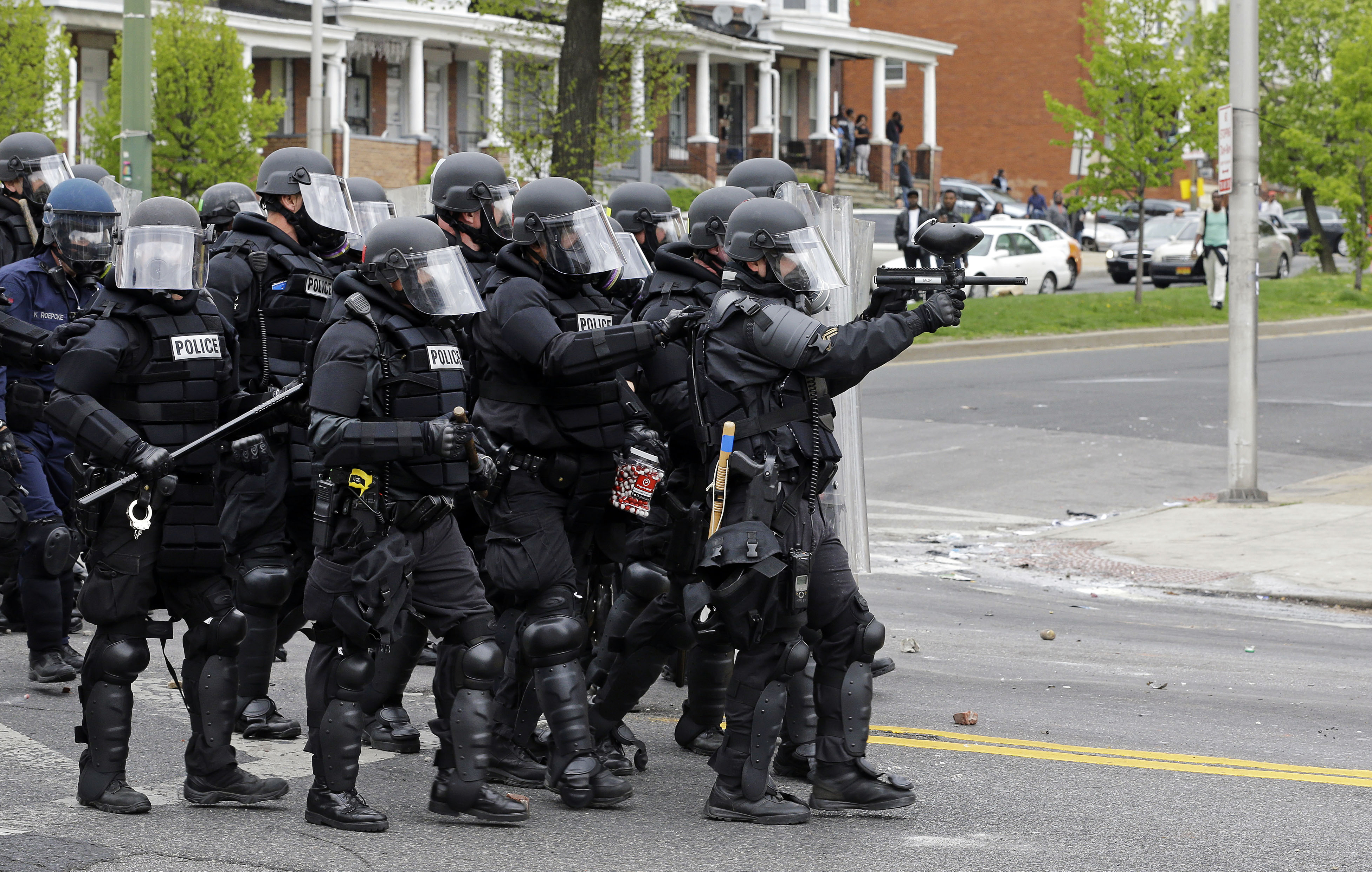 Police move down a street in response to demonstrators who were throwing objects, Monday, April 27, 2015, after the funeral of Freddie Gray in Baltimore. Gray died from spinal injuries about a week after he was arrested and transported in a Baltimore Police Department van. (AP/Patrick Semansky)