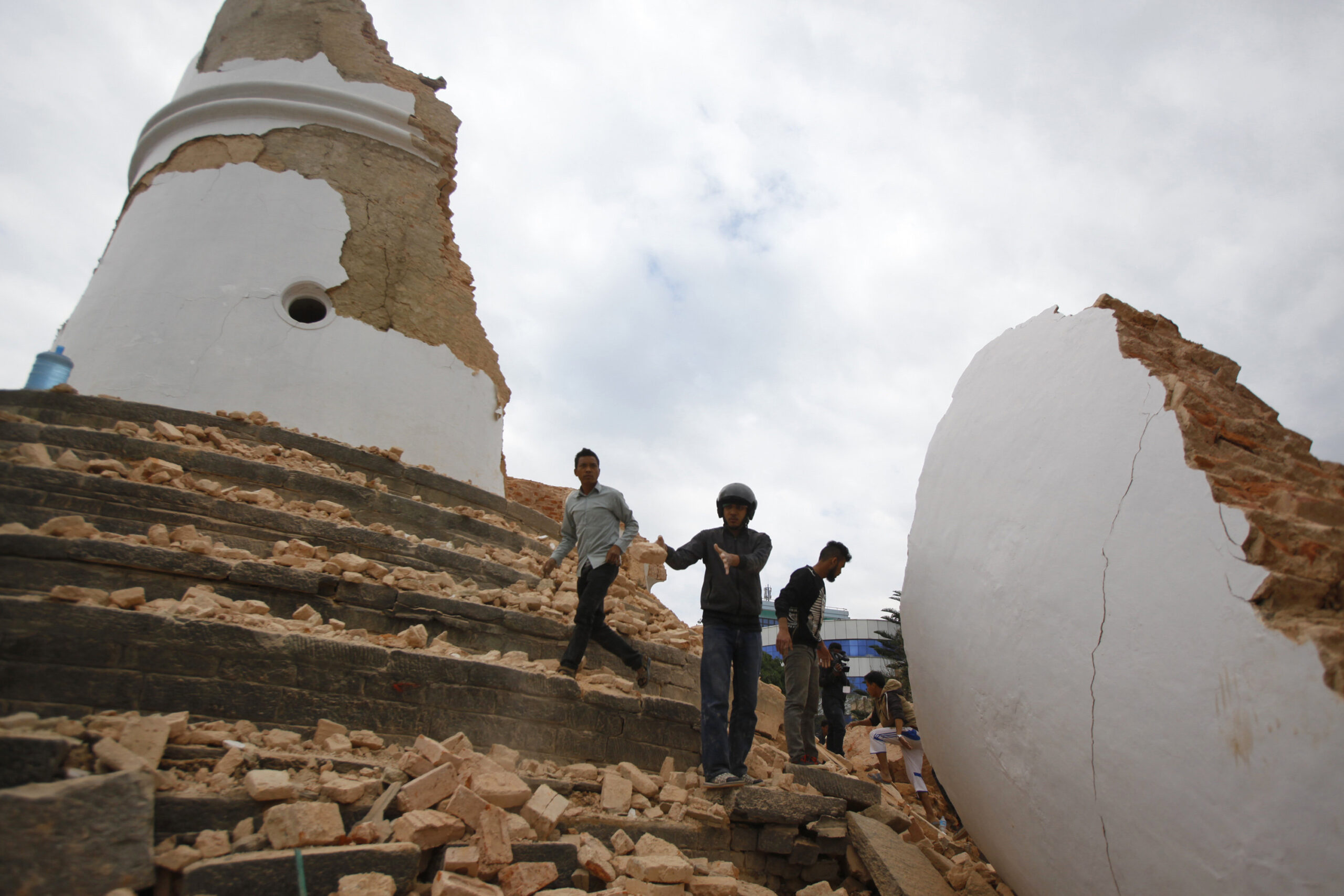 In this Saturday, April 25, 2015, file photo, volunteers work to remove debris at the historic Dharahara tower after an earthquake in Kathmandu, Nepal. A strong magnitude-7.8 earthquake shook Nepal's capital and the densely populated Kathmandu Valley before noon Saturday, causing extensive damage with toppled walls and collapsed buildings, officials said. (AP Photo/ Niranjan Shrestha, File) (Niranjan Shrestha)