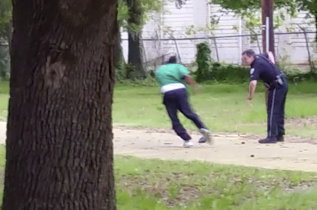 Michael Thomas Slager, right, pulls out his handgun as Walter Scott runs away from him, April 4, 2015, in North Charleston, S.C. (AP/Courtesy of L. Chris Stewart)