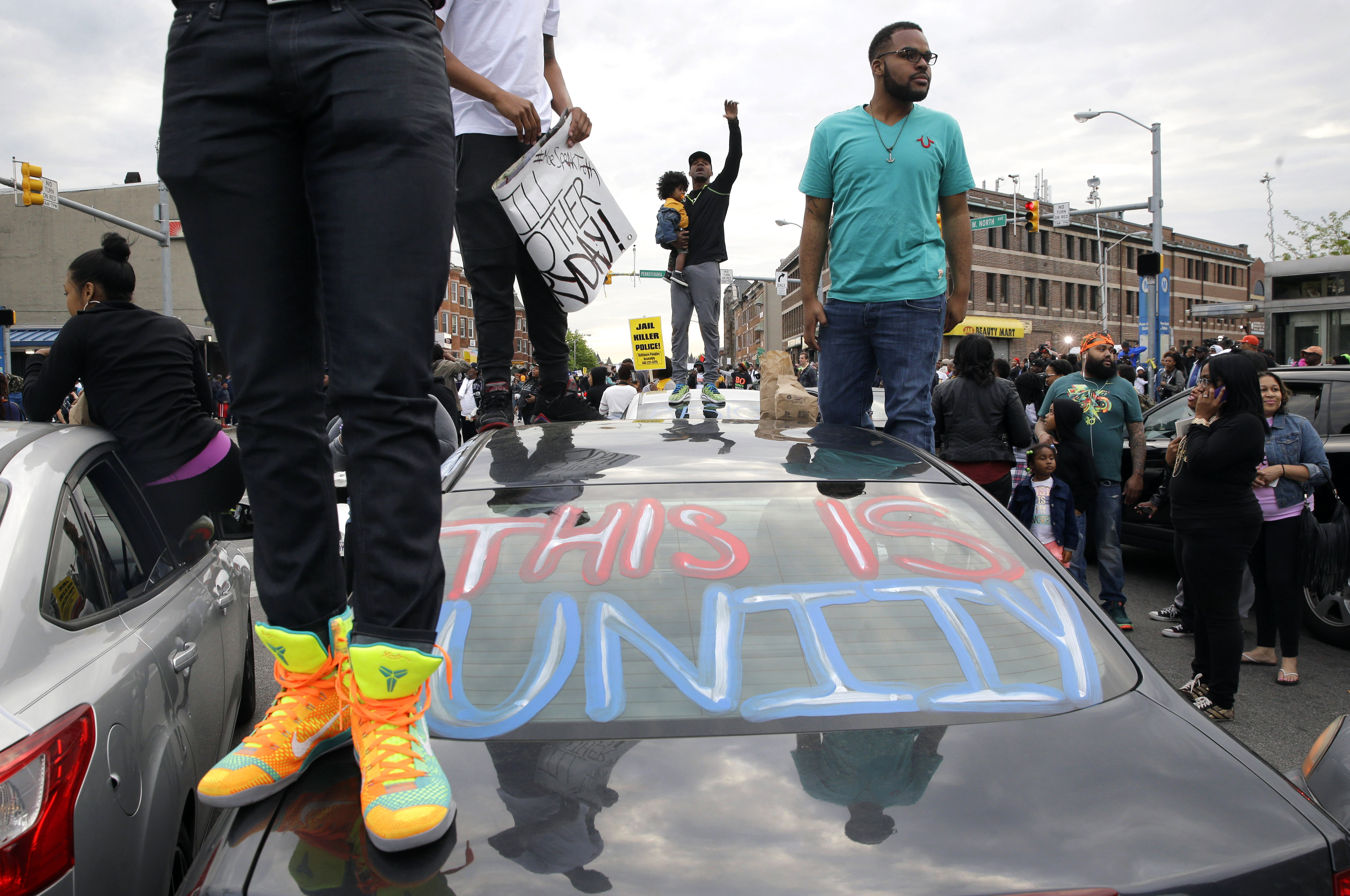 Protesters stand on cars near the intersection of North Avenue and Pennsylvania Avenue in Baltimore, Friday, May 1, 2015, the day of the announcement of charges against the police officers involved in Freddie Gray's arrest. State's Attorney Marilyn Mosby announced the stiffest charge, second-degree "depraved heart" murder, against the driver of the police van that Gray was in after his arrest. Other officers faced charges of involuntary manslaughter, assault and illegal arrest. (AP Photo/Patrick Semansky) (AP)