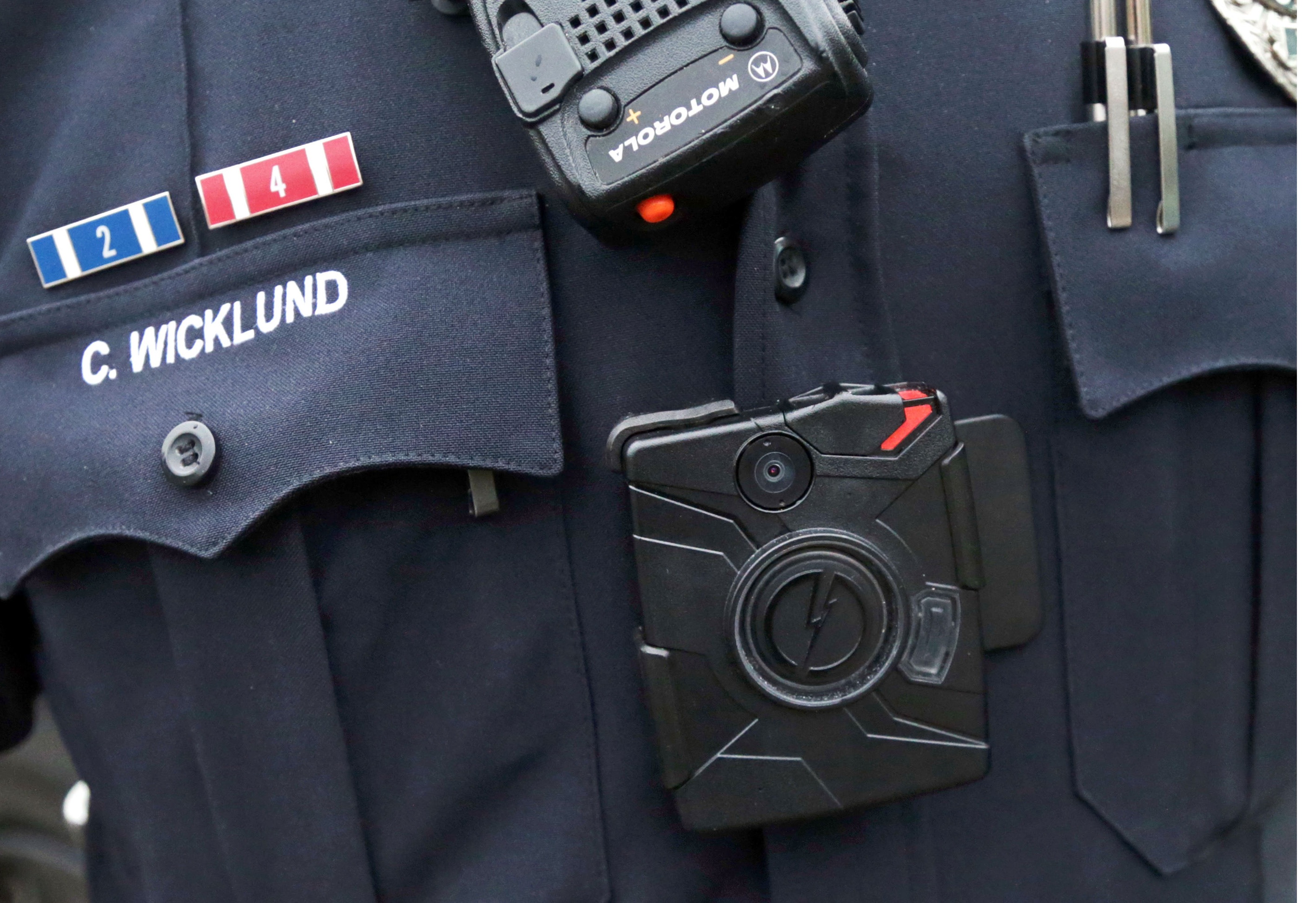 In this Nov. 5, 2014 file photo, Sgt. Chris Wicklund of the Burnsville, Minn., Police Department wears a body camera beneath his microphone. Cleveland's move to buy 1,500 police body cameras and data storage could cost up to $3.3 million over five years, a higher price tag than previously known and an illustration of the long-term costs of such programs with Taser International. (AP)