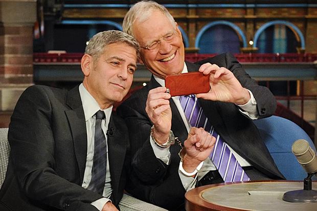 George Clooney handcuffs himself to David Letterman, Thursday May 14, 2015. (CBS/Jeffrey R. Staab)