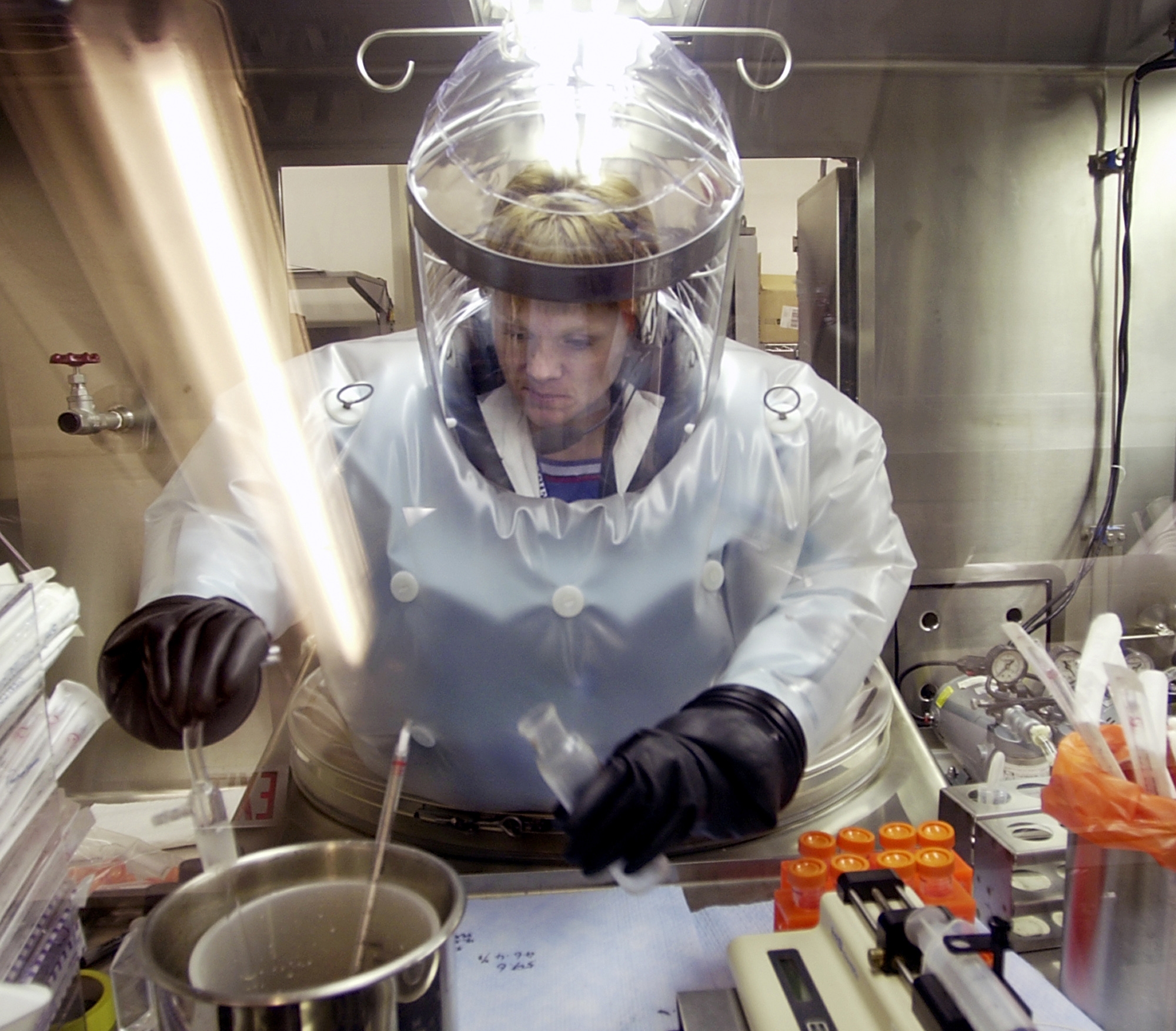 FILE - In this May 11, 2003, file photo, Microbiologist Ruth Bryan works with BG nerve agent simulant in Class III Glove Box in the Life Sciences Test Facility at Dugway Proving Ground, Utah. The specialized airtight enclosure is also used for hands-on work with anthrax and other deadly agents. The Centers for Disease Control and Prevention said it is investigating what the Pentagon called an inadvertent shipment of live anthrax spores to government and commercial laboratories in as many as nine states, as well as one overseas, that expected to receive dead spores. (AP Photo/Douglas C. Pizac, File) (AP)