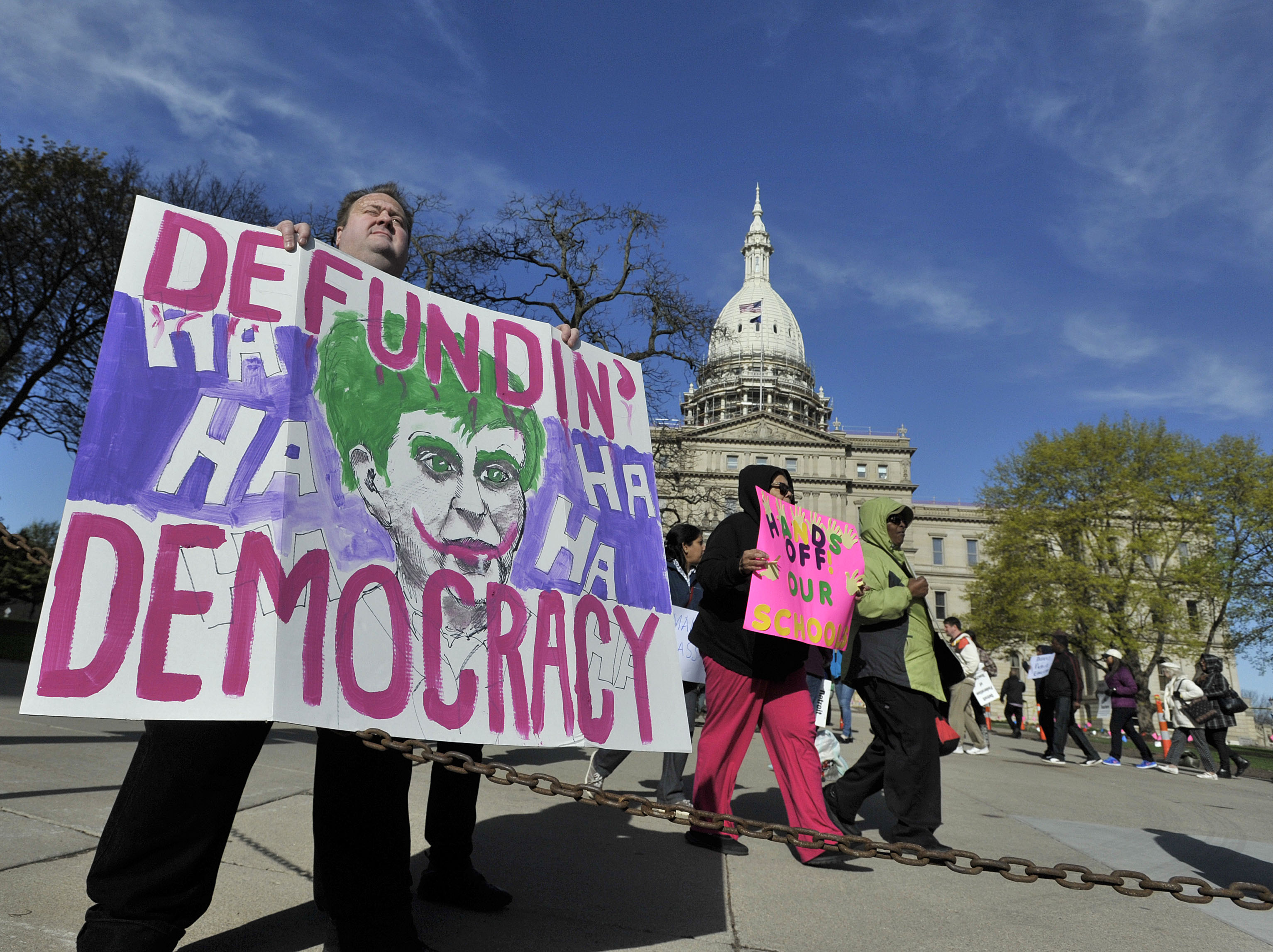 Mike Benson, of Thirkell Elementary, holds up a sign as Detroit Public School teachers demonstrate in front of the Capitol Thursday morning, April 30, 2015, in Lansing, Mich.(Dale G Young/Detroit News via AP) (AP)