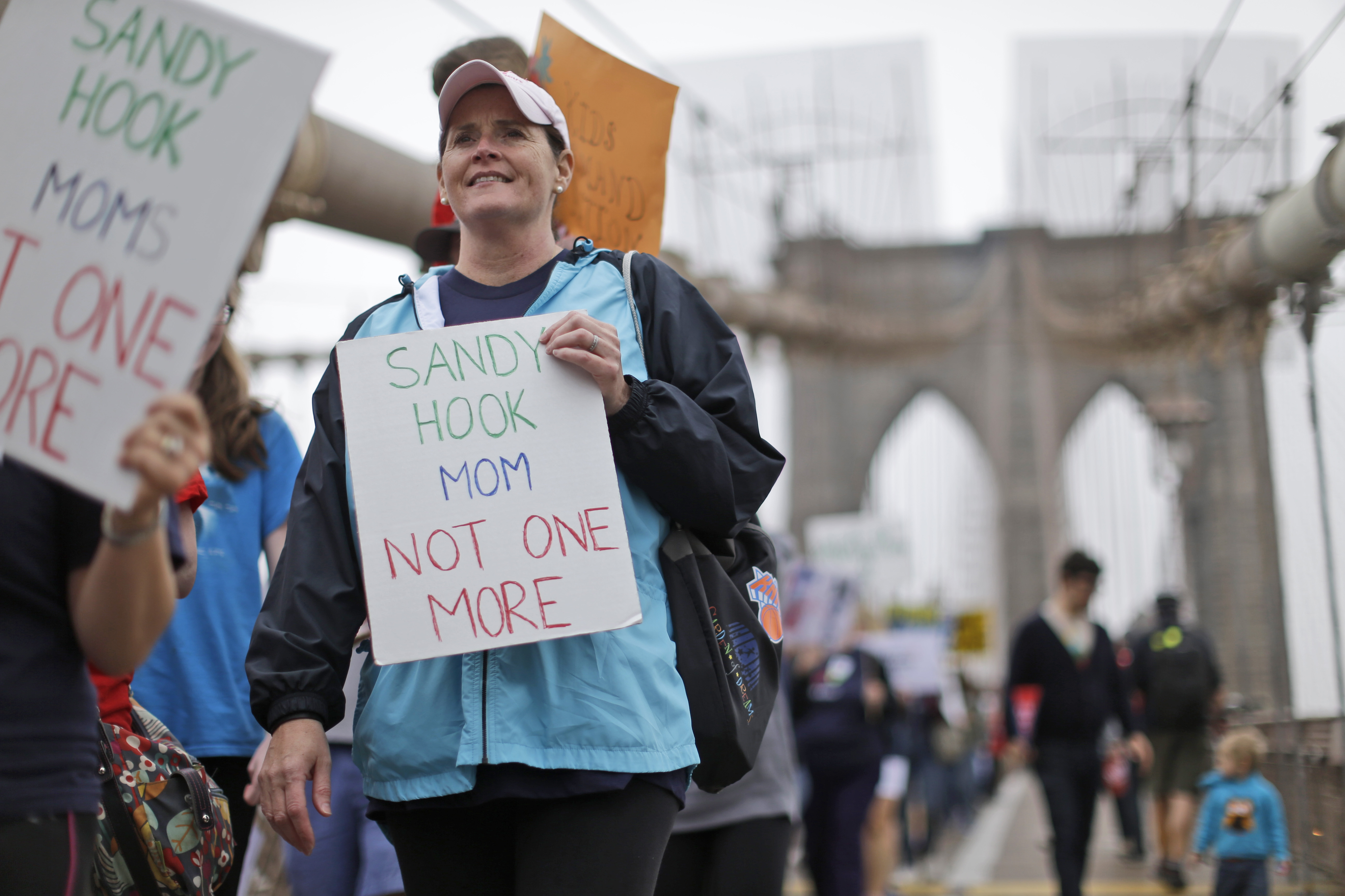 Beth Hegarty, a Sandy Hook Elementary School mother who happened to be inside the school the day of the shooting with her three daughters, all of whom survived, marches over the Brooklyn bridge during the third annual Brooklyn bridge march and rally to end gun violence Saturday, May 9, 2015, in New York. Organizers said the proliferation of guns results in an average of more than 80 deaths a day across the country. (AP Photo/Mary Altaffer) (AP)