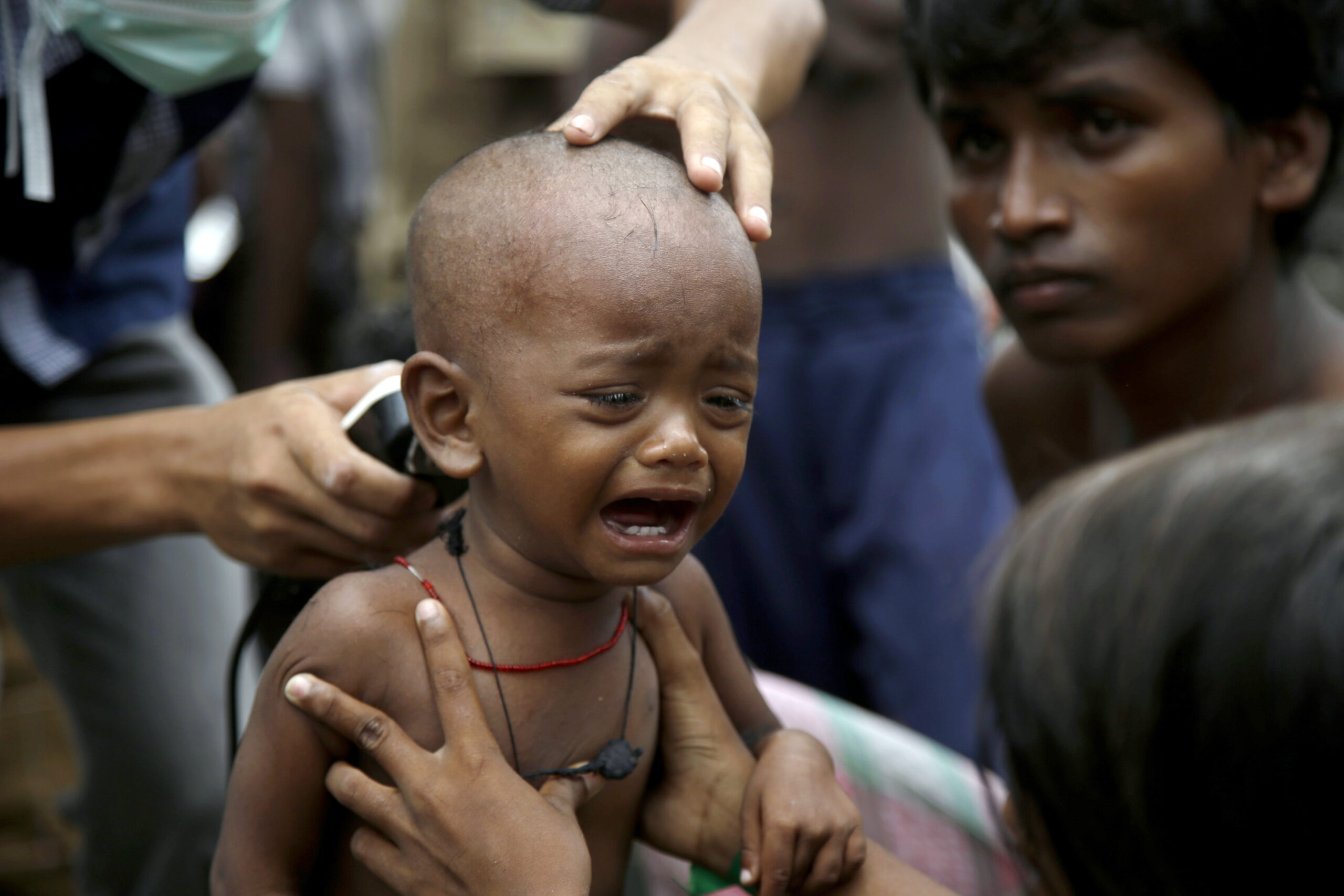 An ethnic Rohingya kid cries after receives a free haircut service provided by a local charity at  temporary shelter in Langsa, Aceh province, Indonesia, Friday, May 22, 2015.Thousands of refugees and migrants have washed ashore in Malaysia, Indonesia and Thailand, about half Rohingya and the rest from Bangladesh, according to the International Organization for Migration. The U.N. refugee agency estimates more than 3,000 others may still be at sea.(AP Photo/Tatan Syuflana) (Tatan Syuflana)