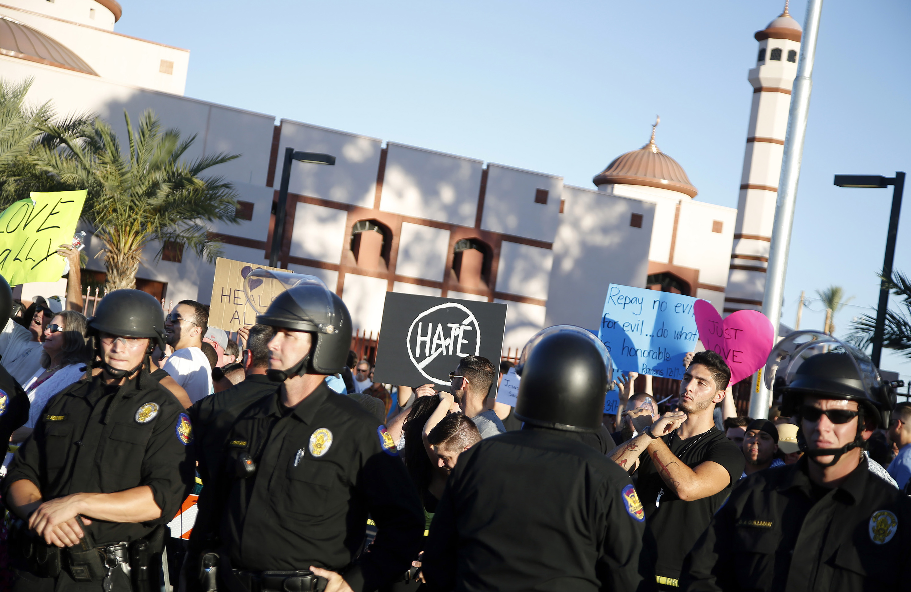 Protesters gather outside the Islamic Community Center of Phoenix, Friday, May 29, 2015. About 500 protesters gathered outside the Phoenix mosque on Friday as police kept two groups sparring about Islam far apart from each other.  (AP Photo/Rick Scuteri) (AP)