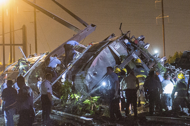 Rescue workers search for victims in the wreckage of a derailed Amtrak train in Philadelphia, Pennsylvania May 12, 2015. (Reuters/Bryan Woolston)