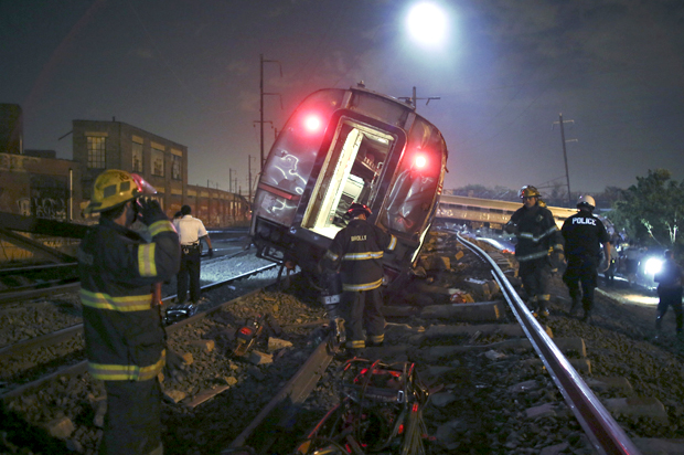 Emergency personnel work the scene of a deadly train wreck, Tuesday, May 12, 2015, in Philadelphia. (AP/Joseph Kaczmarek)