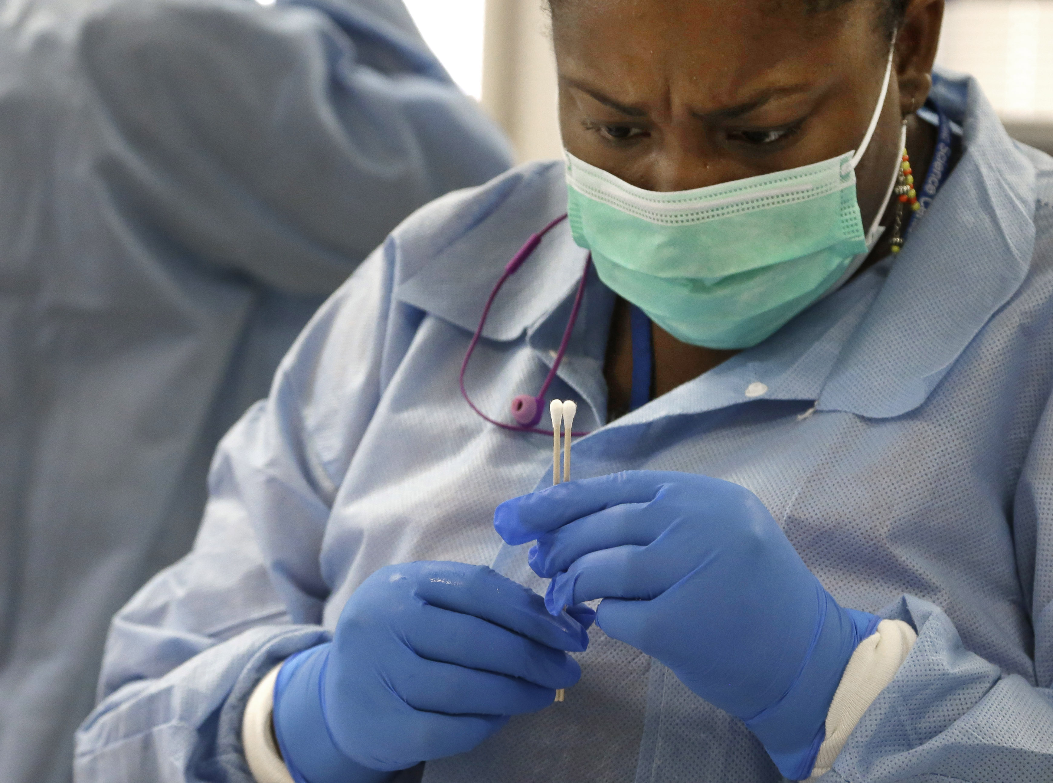 Forensic analyst India Henry examines cotton swabs from a sexual assault evidence kit in the biology lab at the Houston Forensic Science Center in Houston on Thursday, April 2, 2015. A dramatic shift is taking hold across the country as police and prosecutors scramble to process these kits and use DNA matches to track down sexual predators, many of whom attacked more women while evidence of their crimes languished in storage. Lawmakers, meanwhile, are proposing reforms to ensure this doesn't happen again. (AP Photo/Pat Sullivan) (AP)
