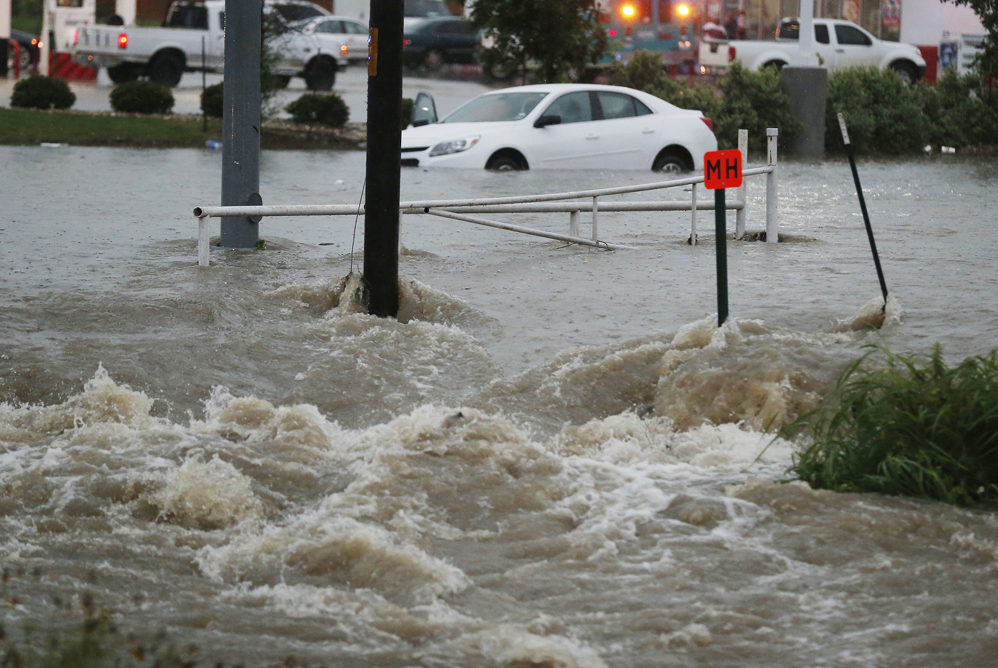 A motorist is rescued from a car trapped at a low spot near  an  intersection Monday, May 25, 2015 in Waco, Texas. Widespread flooding and trapped vehicles were reported throughout the area. (Rod Aydelotte/Waco Tribune Herald  via AP) (AP)