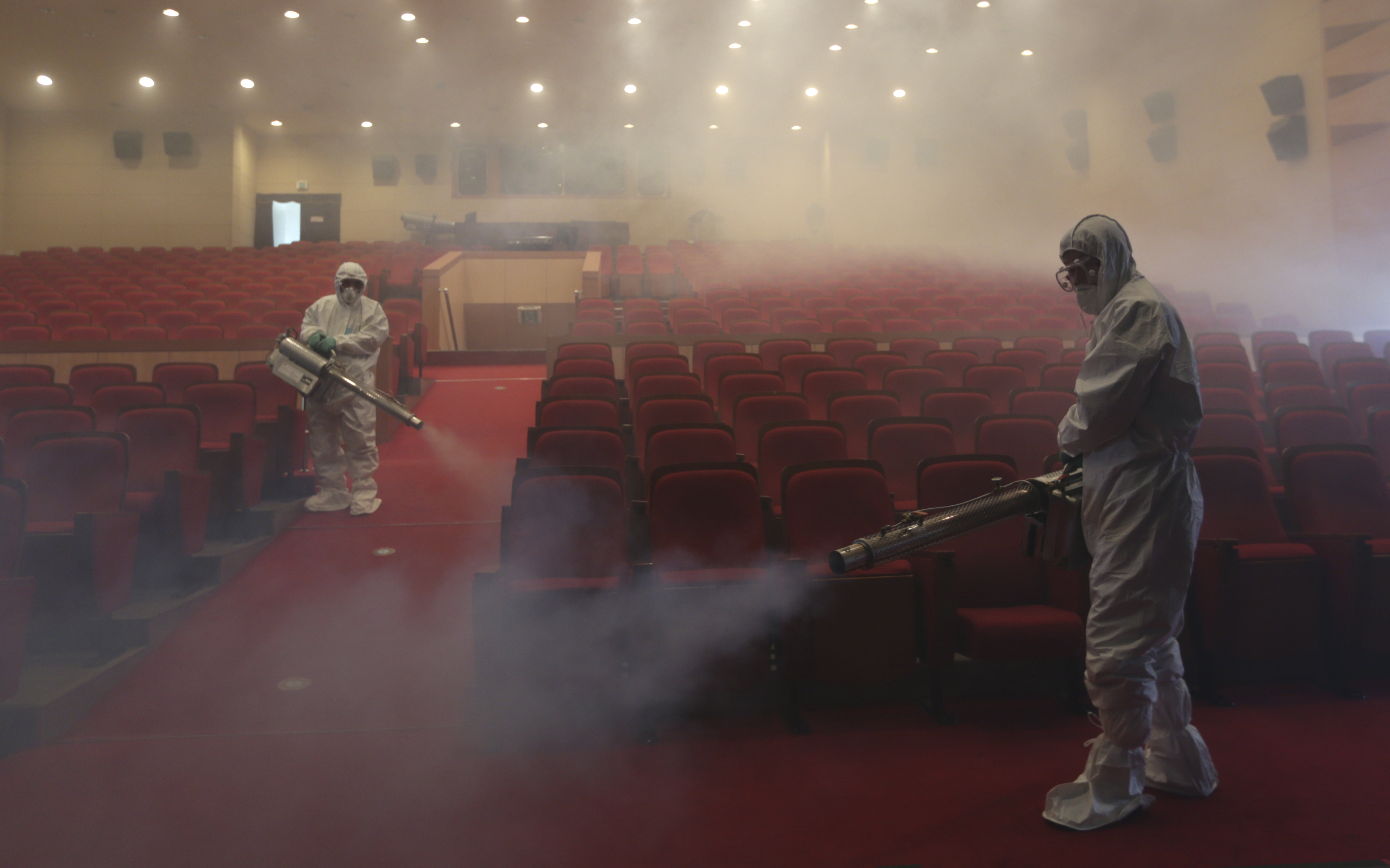 AP10ThingsToSee - Workers wearing protective suits fumigate an art hall with antiseptic solution as a precaution against the spread of the MERS (Middle East Respiratory Syndrome) virus in Seoul, South Korea on Friday, June 12, 2015. (AP Photo/Lee Jin-man) (AP)