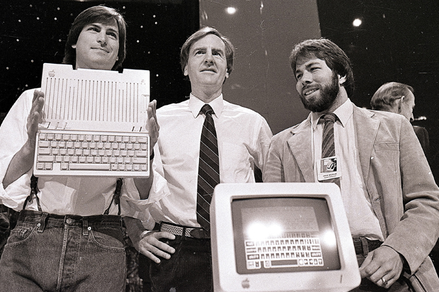 Steve Jobs, John Sculley, and Steve Wozniak unveil the later Apple IIc computer, April 24, 1984. (AP/Sal Veder)