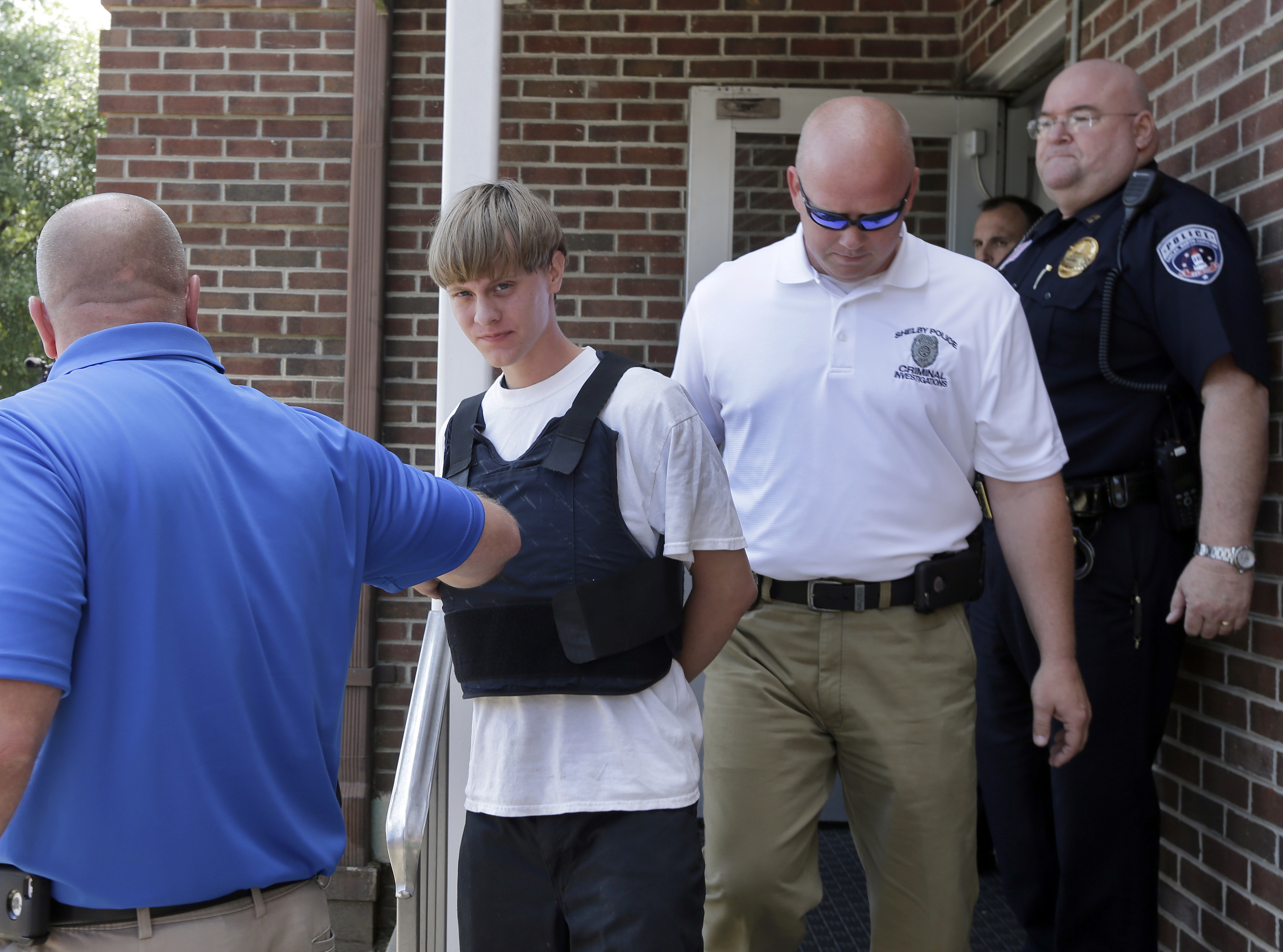 Charleston, S.C., shooting suspect Dylann Storm Roof, center, is escorted from the Shelby Police Department in Shelby, N.C., Thursday, June 18, 2015. Roof is a suspect in the shooting of several people Wednesday night at the historic The Emanuel African Methodist Episcopal Church in Charleston, S.C. (AP Photo/Chuck Burton) (AP)