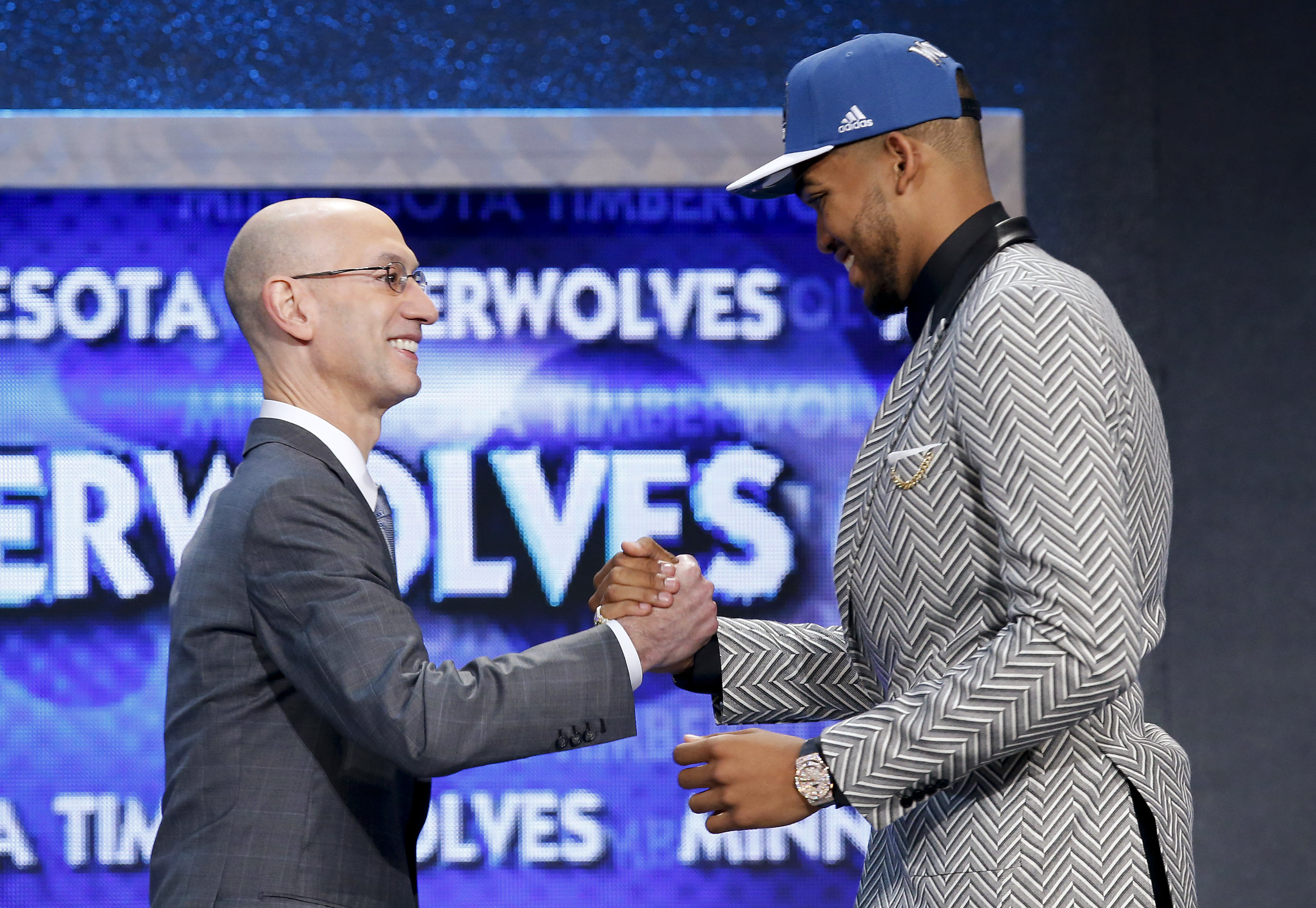 Karl-Anthony Towns, right, is greeted by NBA Commissioner Adam Silver after being announced as the top pick, by the Minnesota Timberwolves, at the NBA basketball draft Thursday, June 25, 2015, in New York. (AP Photo/Kathy Willens) (AP)
