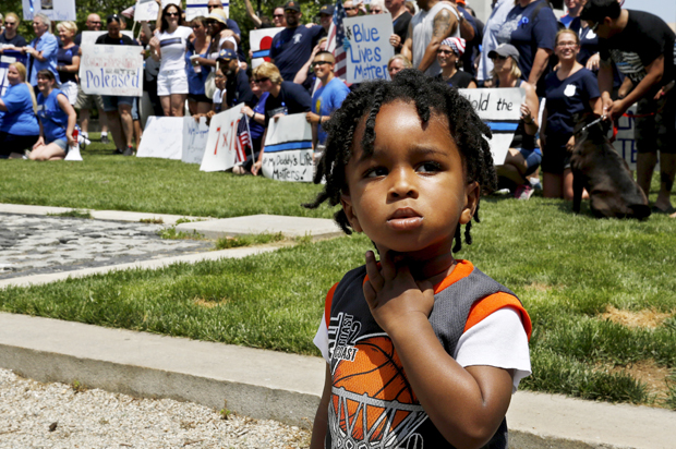 King Walker of Baltimore stands in front of a gathering of police officers and their supporters at a "Blue Lives Matter" rally, Baltimore, Maryland, May 30, 2015. (Reuters/Jim Bourg)