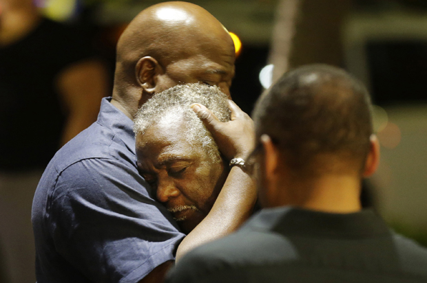 Worshippers embrace across the street from the scene of a shooting at Emanuel AME Church, Wednesday, June 17, 2015, in Charleston, S.C. (AP/David Goldman)