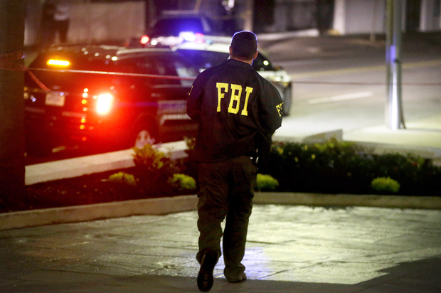 An FBI agent walks across the street from the Emanuel AME Church following the shooting, Wednesday, June 17, 2015, in Charleston, S.C. (AP/David Goldman)