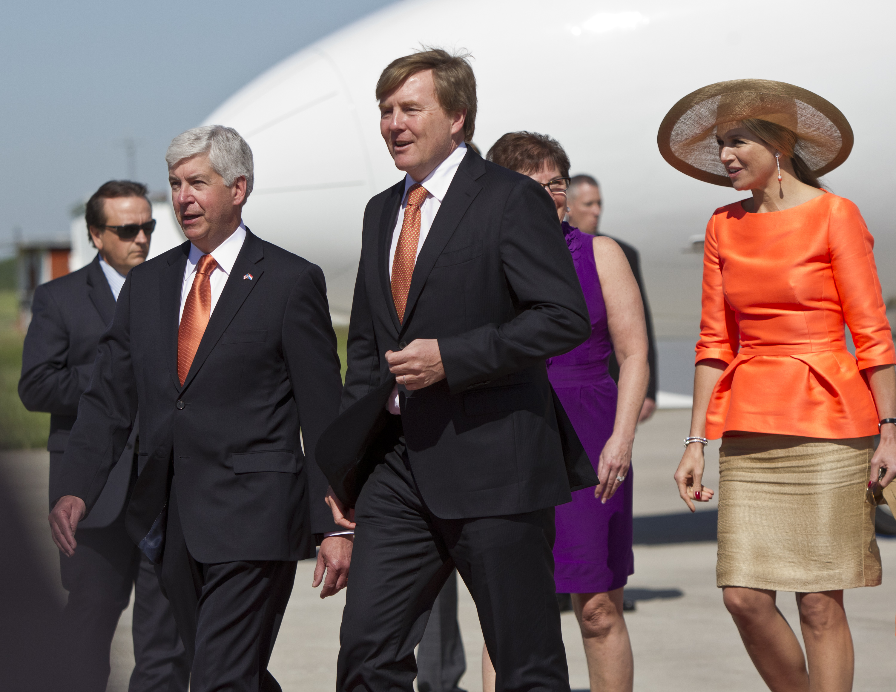 Dutch King Willem-Alexander, center, and Queen Maxima, right, walk near Gov. Rick Snyder after arriving at the Gerald R. Ford International Airport in Grand Rapids, Mich., Tuesday, June 2, 2015. Plans call for a luncheon with Gov. Snyder and visits with local leaders. The king and queen leave Tuesday afternoon for Chicago. The king and his wife are on a multi-day trip to the U.S. (Cory Morse/The Grand Rapids Press via AP) ALL LOCAL TELEVISION OUT; LOCAL TELEVISION INTERNET OUT (AP)