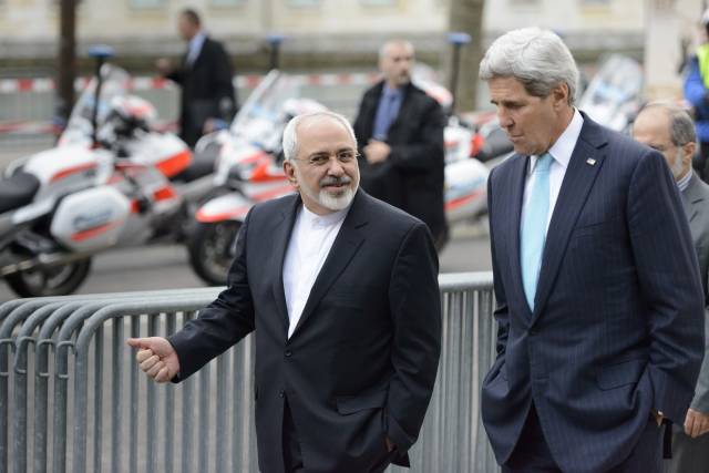 U.S. Secretary of State John Kerry speaks with Iranian Foreign Minister Mohammad Javad Zarif (Laurent Gillieron/Keystone via AP)