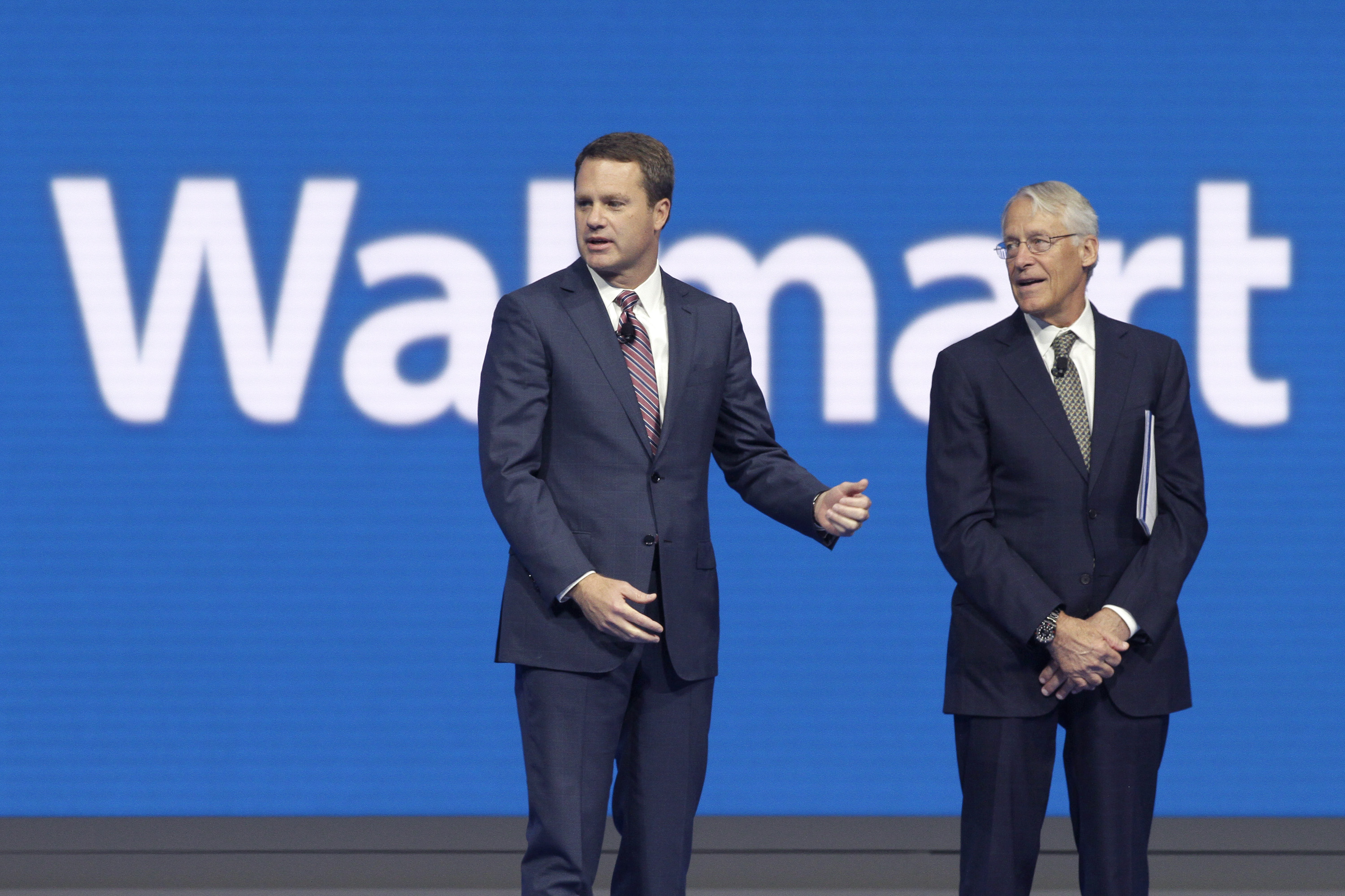 Doug McMillon, left, CEO of Wal-Mart Store, Inc., is speaks with Rob Walton, company CFO and son of Wal-Mart founder Sam Walton at the Wal-Mart shareholder meeting in Fayetteville, Ark., Friday, June 5, 2015. (AP Photo/Danny Johnston) (AP)