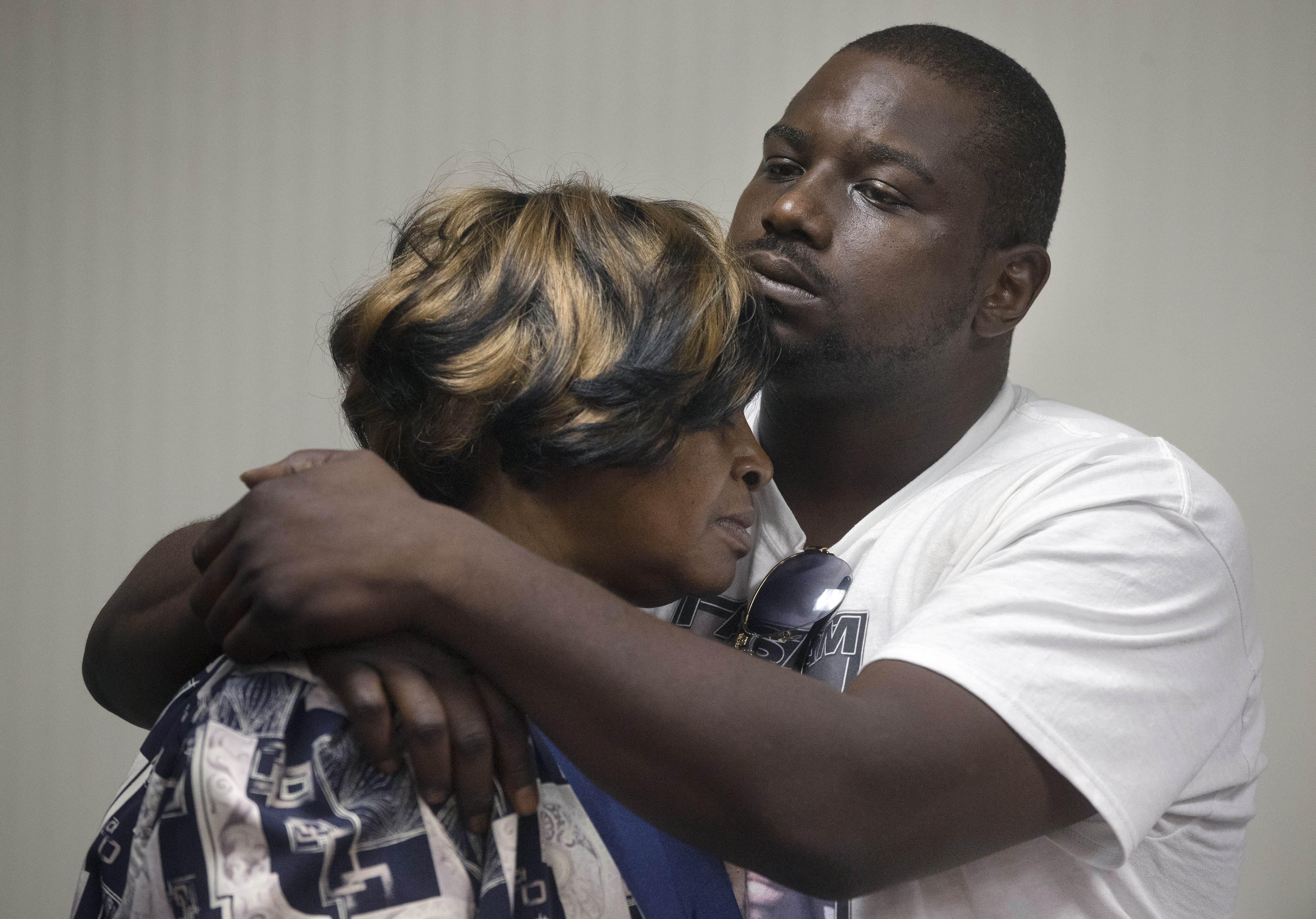 Aubrey DuBose, right, holds his mother Audrey during a news conference after murder and manslaughter charges against University of Cincinnati police officer Ray Tensing were announced for the traffic stop shooting death of motorist Samuel DuBose, Wednesday, July 29, 2015, in Cincinnati. (AP Photo/John Minchillo) (AP)