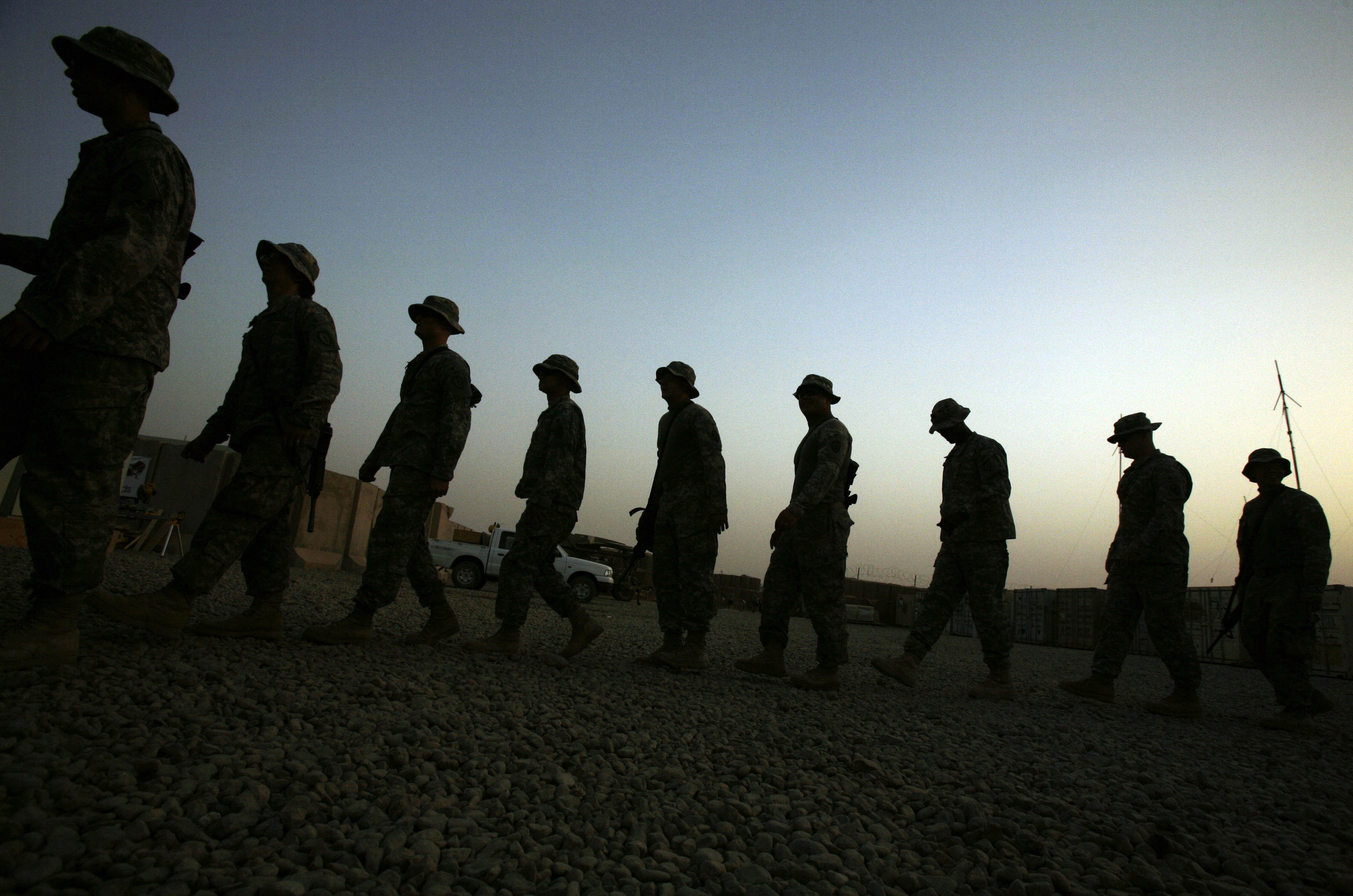 FILE - In this June 29, 2009 file photo, U.S. Army soldiers walk in a line at a reenlistment ceremony for a comrade in Baqouba, Iraq. New research published Wednesday, July 8, 2015 in JAMA Psychiatry shows war-time suicide attempts in the Army are most common in early-career enlisted soldiers who have not been deployed, while officers are less likely to try to end their lives. The study looked at data on nearly 1,000 suicide attempts among almost 1 million active-duty Army members during the wars in Afghanistan and Iraq, from 2004 to 2009. (AP Photo/Maya Alleruzzo, File) (AP)