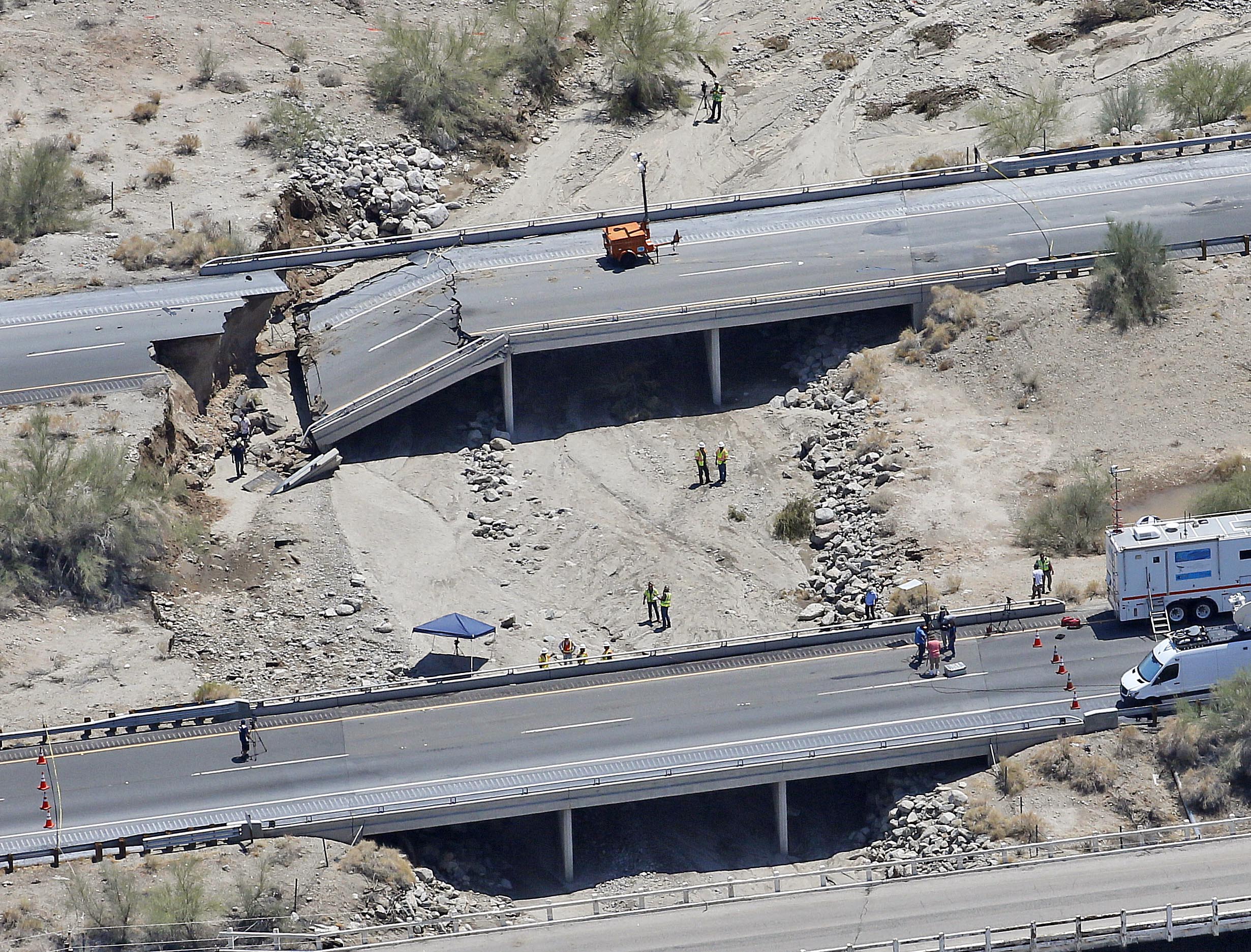 This aerial photo shows the collapsed elevated section of Interstate 10, Monday, July 20, 2015, in Desert Center, Calif. All traffic along one of the major highways connecting California and Arizona was blocked indefinitely when the bridge over a desert wash collapsed during a major storm, and the roadway in the opposite direction sustained severe damage. (AP Photo/Matt York) (AP)