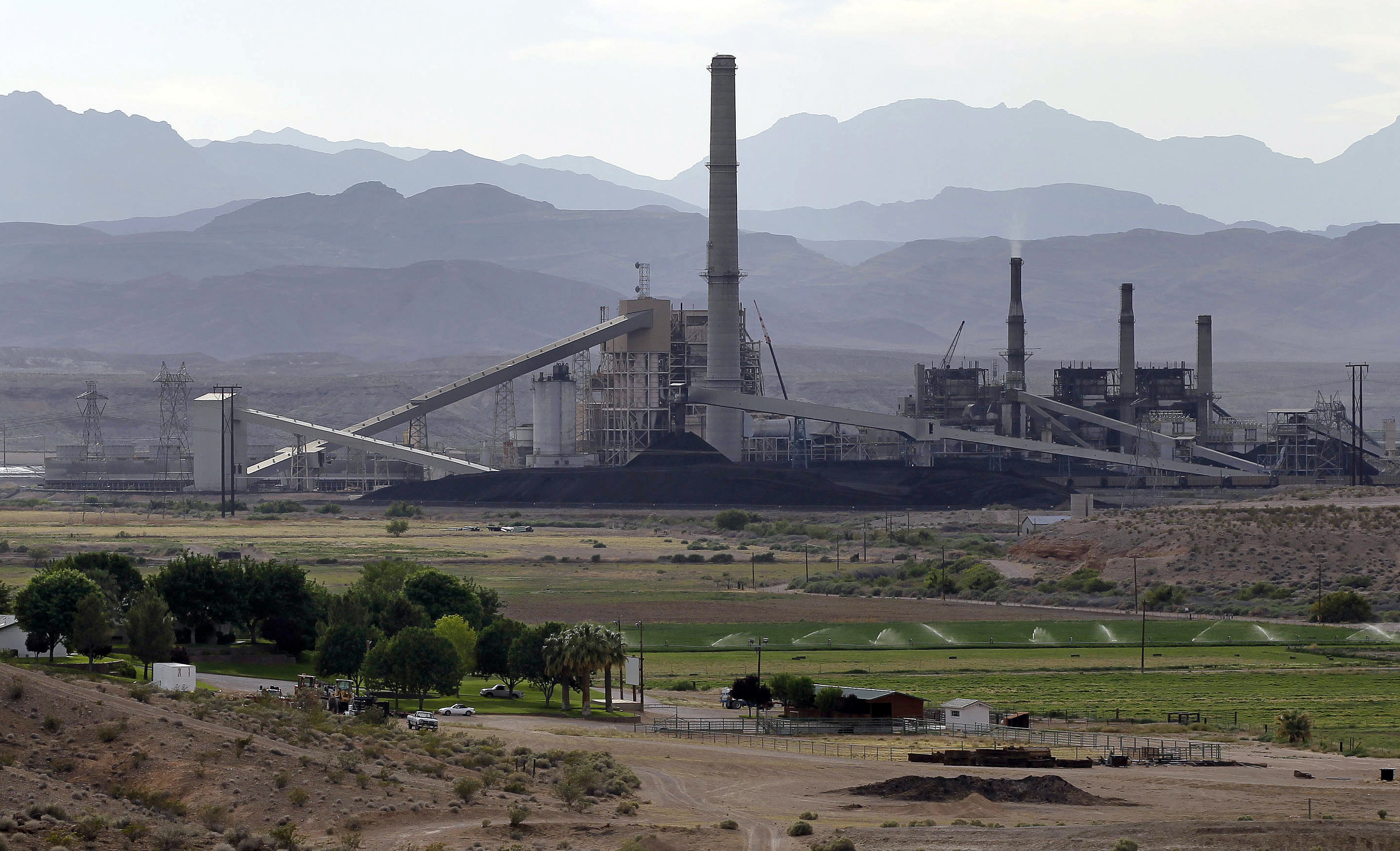 FILE - This May 14, 2012, file photo, shows the Reid-Gardner power station on the Moapa Indian Reservation, in Moapa, Nev. Nevadas main electric utility is agreeing to pay $4.3 million to clean up contamination at the coal-fired power plant near Las Vegas that neighboring Native Americans blame for residential health problems and pollution of a tributary to the Lake Mead reservoir and Colorado River. () (AP Photo/Julie Jacobson, File)