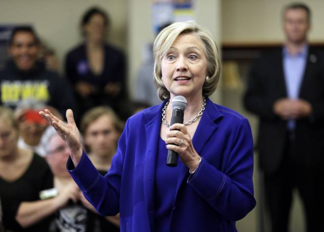 Democratic presidential candidate Hillary Rodham Clinton speaks to local residents during a campaign stop at the Iowa City Public Library (AP Photo/Charlie Neibergall)