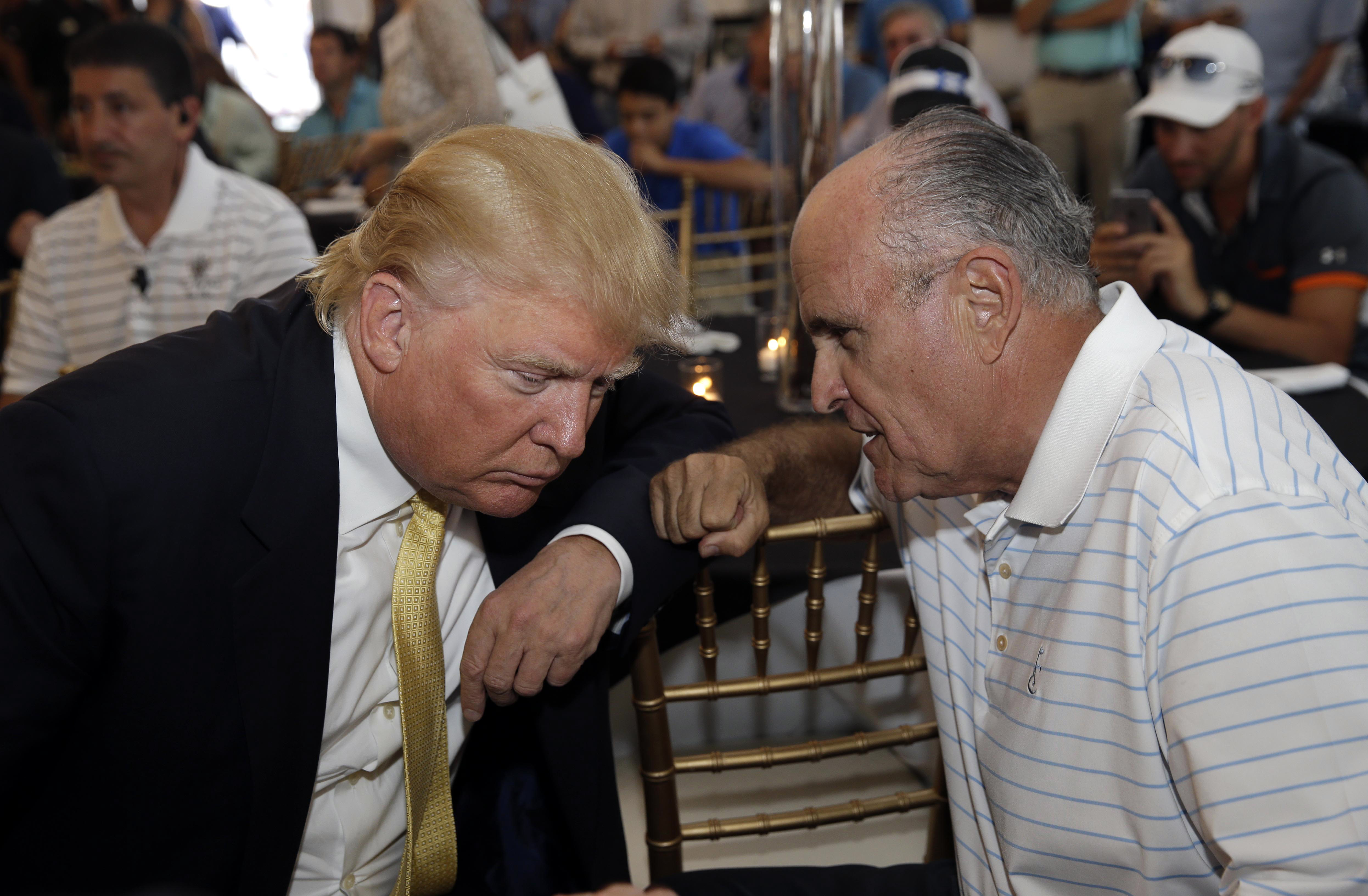 Republican presidential candidate Donald Trump, left, talks the former New York City mayor Rudy Giuliani at a fundraising event in the Bronx borough of New York, Monday, July 6, 2015. (AP Photo/Seth Wenig) (AP)