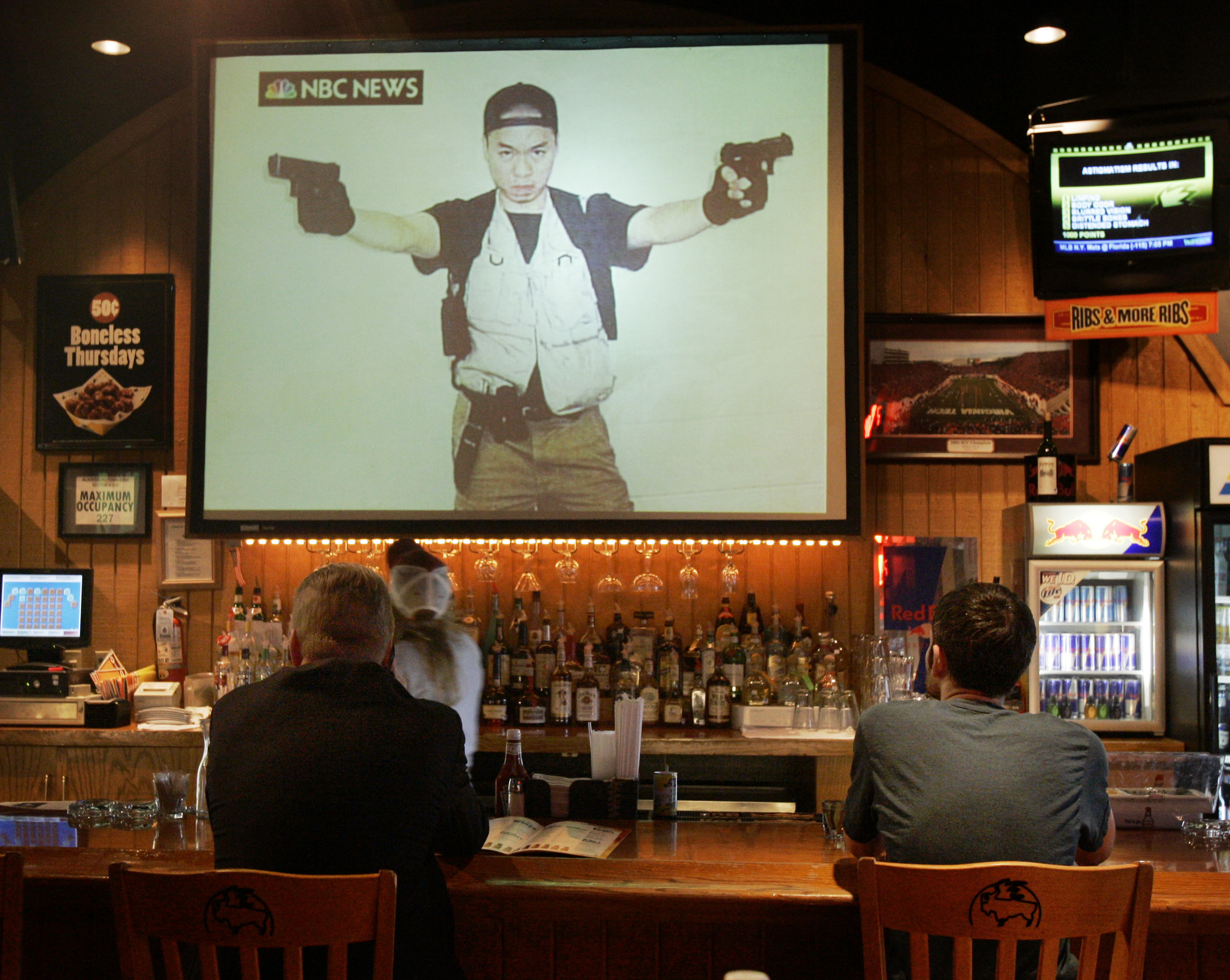 FILE - In this Wednesday, April 18, 2007 file photo, customers look at an image of Virginia Tech gunman Cho Seung-Hui broadcast on NBC Nightly News in a local restaurant in Blacksburg, Va. Cho mailed a package to NBC that contained photos of him brandishing guns and video of him delivering an angry, profanity laced tirade. While mass killing incidents seize public attention, there's far less focus on the serious, systemic problems besetting America's mental health system, says Jeffrey Swanson, a professor of psychiatry at Duke University School of Medicine. (AP Photo/Amy Sancetta) (AP)