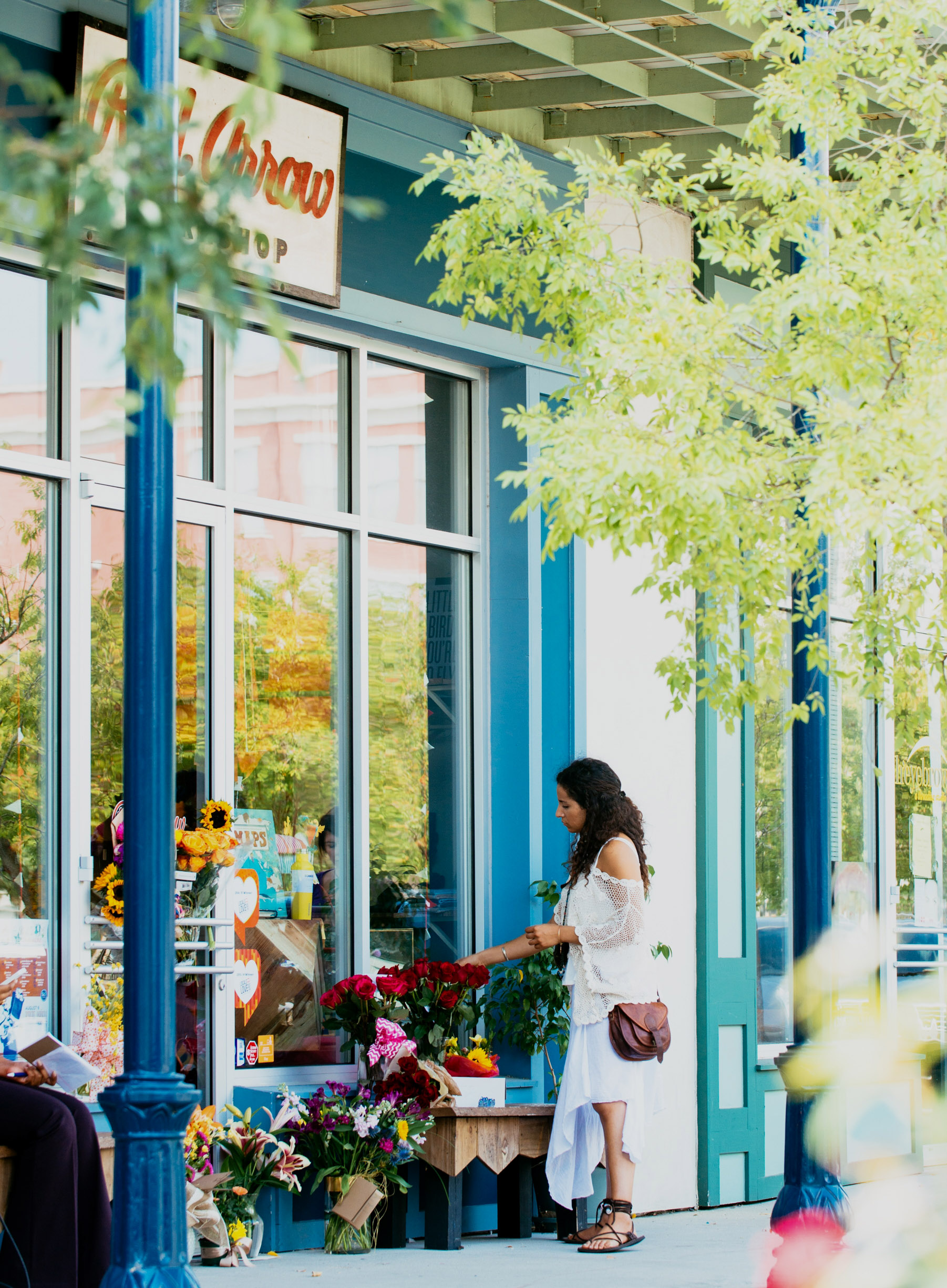 Melodie McMath looks at flowers at a make-shift memorial outside of the Red Arrow business for the owner Jillian Johnson, a victim of the the movie theater shooting, in Lafayette, La. on Friday, July 24, 2015. Johnson was one of two women killed in an attack in Lafayette on Thursday night. John Russel Houser, 59, stood up about 20 minutes into a movie and fired first at two people sitting in front of him, then aimed his handgun at others, firing at least 13 times, police said Friday. (AP Photo/Denny Culbert) (Denny Culbert)