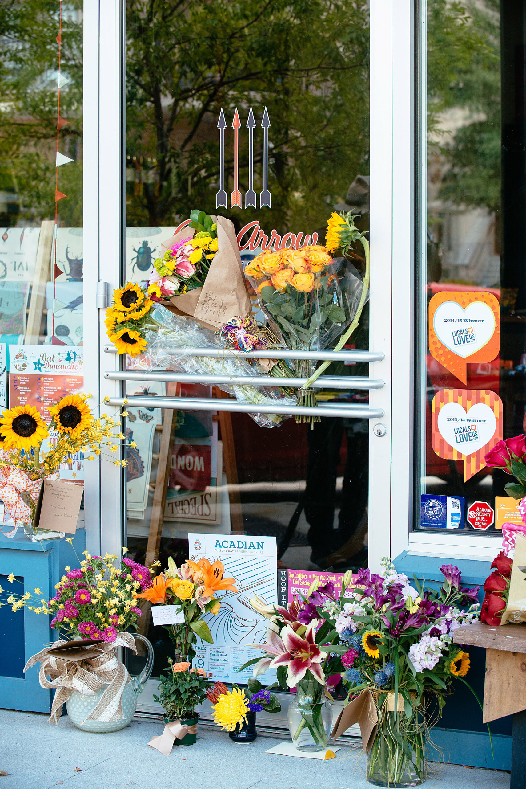 A small memorial is shown outside of the Red Arrow business for the owner Jillian Johnson, a victim of the the movie theater shooting, in Lafayette, La. on Friday, July 24, 2015 Johnson was one of two women killed in an attack in Lafayette Thursday night. John Russel Houser, 59, stood up about 20 minutes into a movie and fired first at two people sitting in front of him, then aimed his handgun at others, firing at least 13 times, police said Friday. (AP Photo/Denny Culbert) (Denny Culbert)