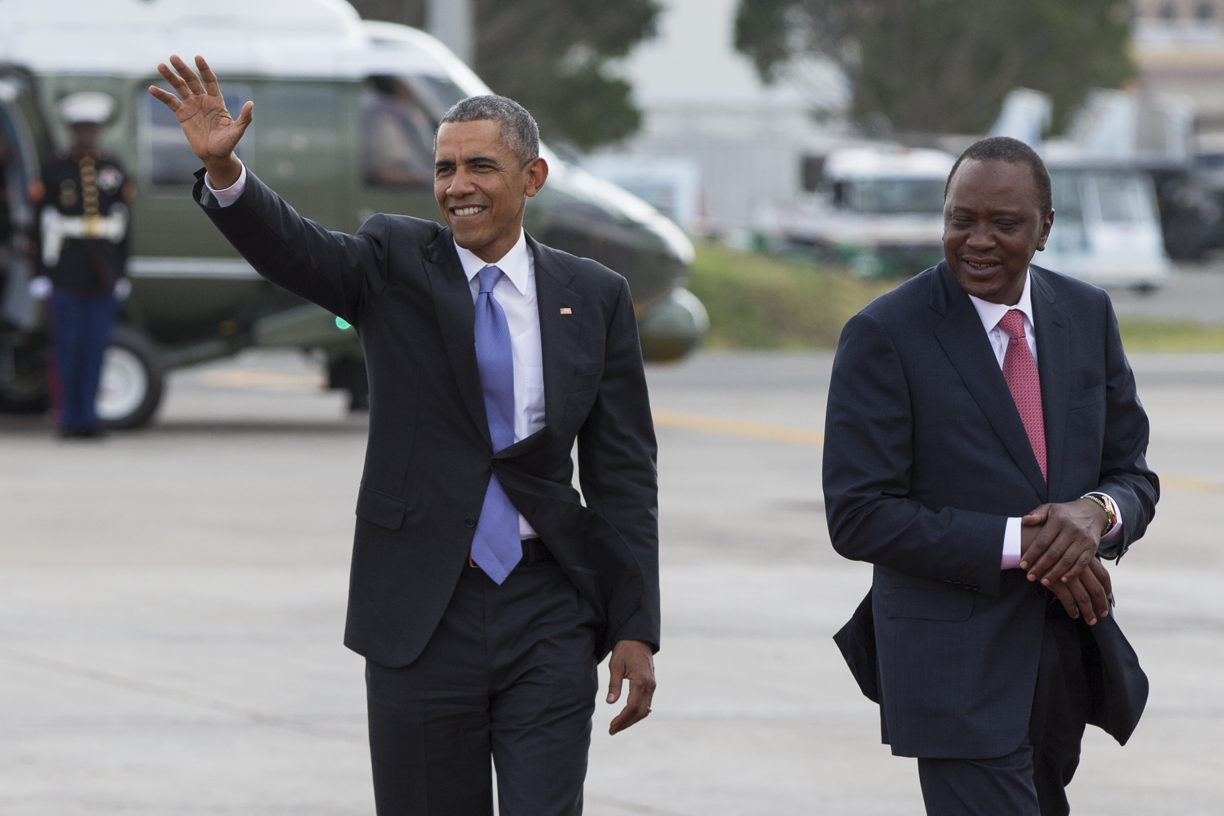 Kenyan President Uhuru Kenyatta, right, escorts President Barack Obama while departing Kenyatta International Airport, on Sunday, July 26, 2015, in Nairobi. On the final day of his visit in Kenya, Obama laid out his vision for Kenya's futurevand broad themes of U.S.-Kenya relations. (AP Photo/Evan Vucci) (AP)