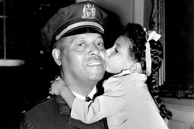 Lt. Samuel Battle gets a kiss from his granddaughter Yvonne, at City Hall in New York, Sept. 4, 1941. (AP)